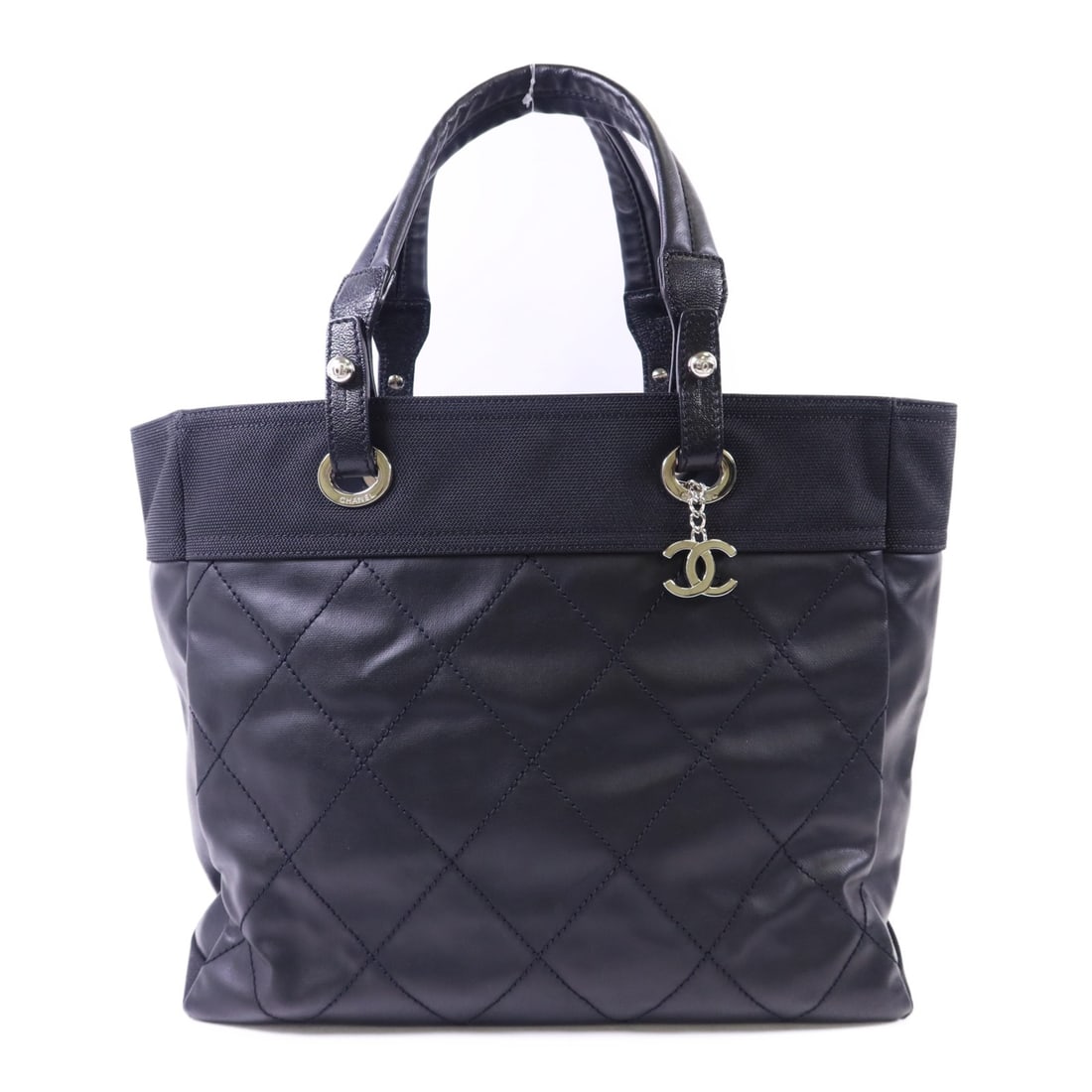 Chanel Paris Biarritz Black Tote PVC Coated Canvas and Nylon Bag: Chanel Paris Biarritz Black Tote PVC Coated Canvas and Nylon Bag This CHANEL Paris Biarritz tote bag features a black PVC coated canvas exterior with nylon accents. Designed in a classic tote style, i