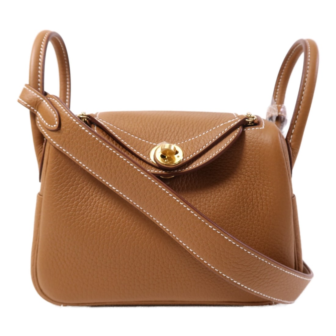 Mini Lindy Shoulder Bag by Hermes in Gold Clemence Leather with GHW: Mini Lindy Shoulder Bag by Hermes in Gold Clemence Leather with GHW This Hermes Mini Lindy 2-way shoulder bag features luxurious Clemence calfskin leather in a gold tone. Designed for versatility, it