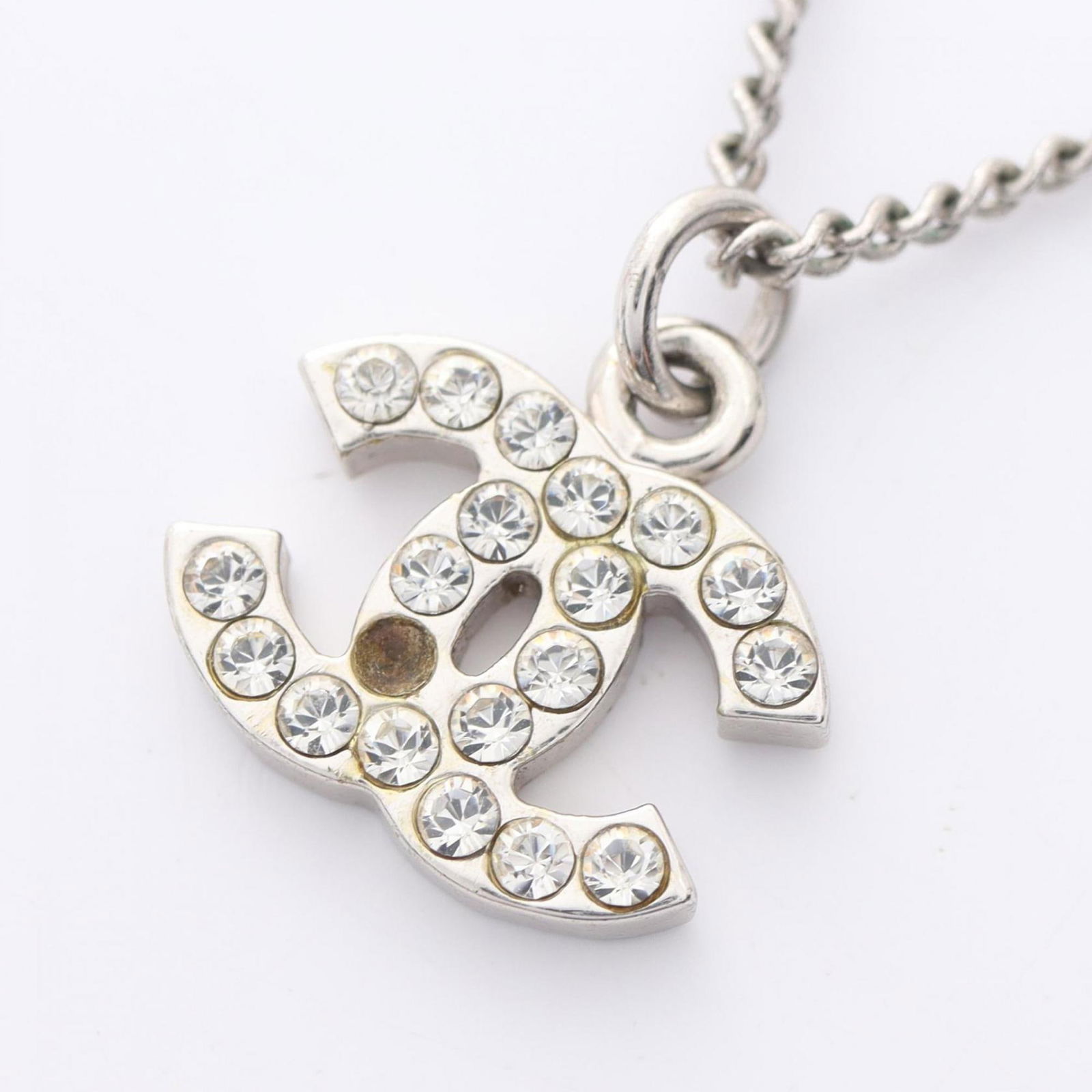 Chanel Coco Mark Steel Pendant Necklace in Silver Tone: Chanel Coco Mark Steel Pendant Necklace in Silver Tone This Chanel Coco Mark necklace features a silver-tone steel construction with a pendant adorned with stones. The necklace is designed for women a