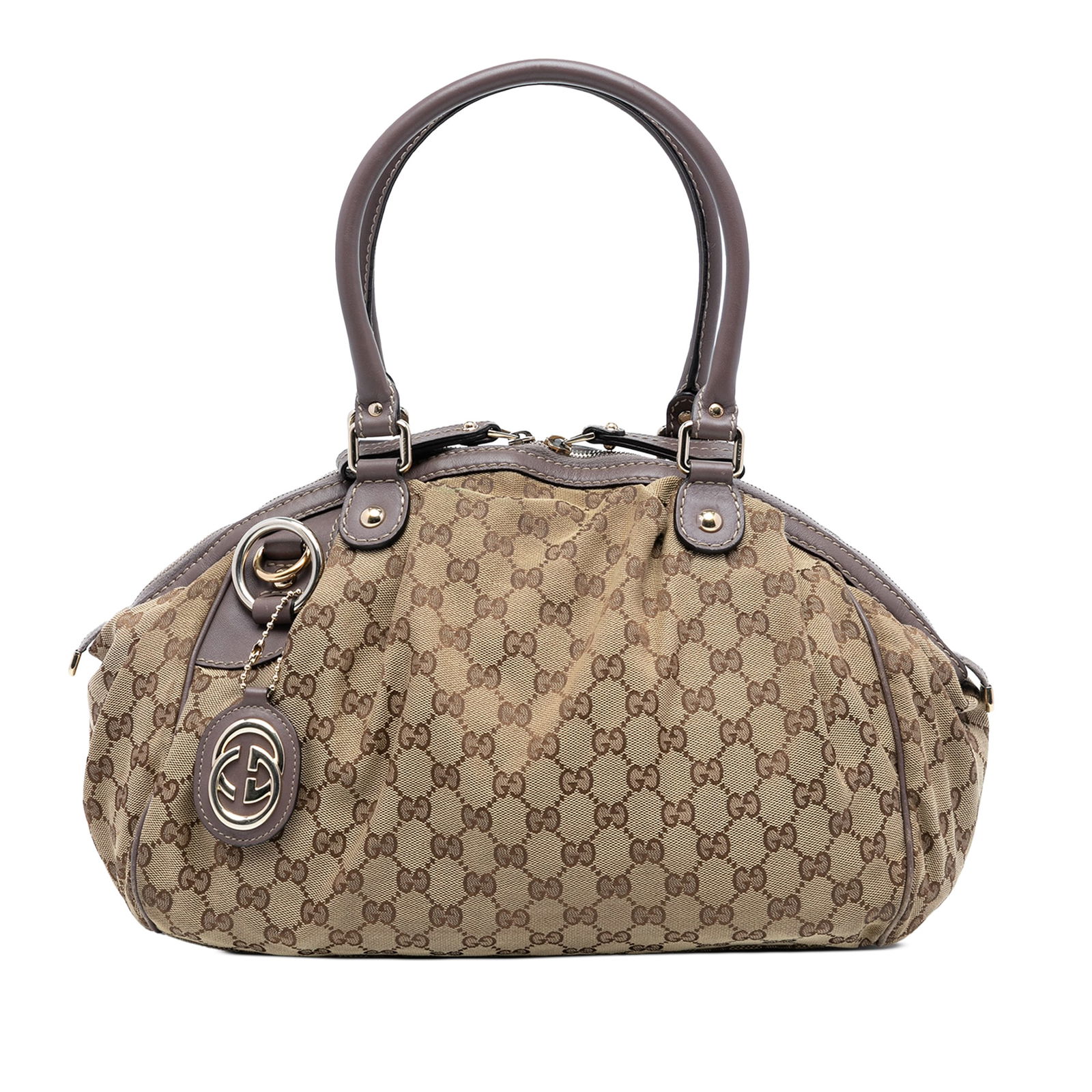 Brown Canvas Gucci Sukey Satchel with Leather Trim and Top Zip: Brown Canvas Gucci Sukey Satchel with Leather Trim and Top Zip This Gucci GG Canvas Sukey Satchel features a canvas body with leather trim, rolled leather handles, a top zip closure, and an interior z