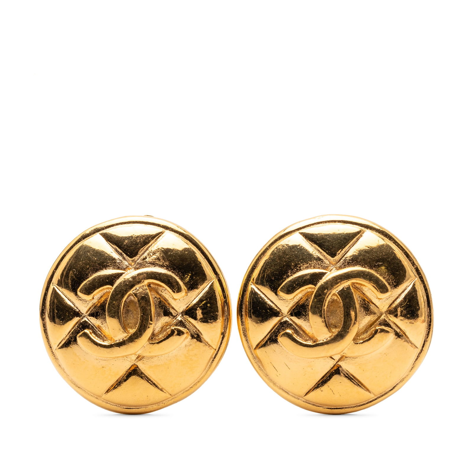 Chanel CC Quilted Gold Plated Metal Clip On Earrings: Chanel CC Quilted Gold Plated Metal Clip On Earrings These Chanel earrings feature a round, quilted design crafted from gold-plated metal with a clip-on closure. The earrings are categorized as costum