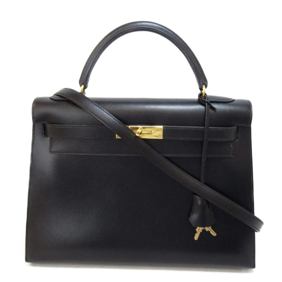 Black Leather Hermes Kelly 32 Handbag with Strap and Handle: Black Leather Hermes Kelly 32 Handbag with Strap and Handle The Hermes Kelly 32 is a classic handbag crafted from black leather. This model features a width of 32 cm, a height of 23 cm, and a depth of