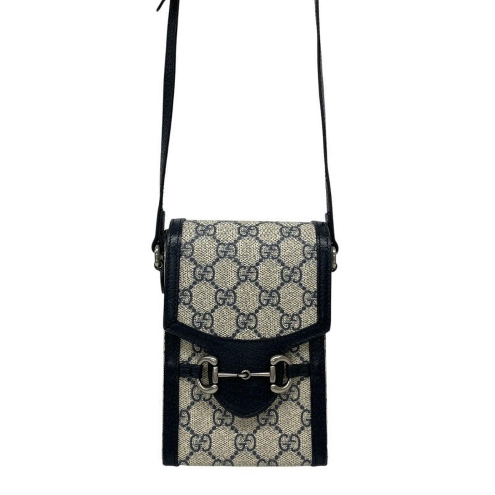 Navy Canvas Gucci Horsebit Small Bag with Italian Craftsmanship: Navy Canvas Gucci Horsebit Small Bag with Italian Craftsmanship This is a Gucci Horsebit accessory in navy canvas, designed for unisex use. It features a compact structure with metal fittings and show