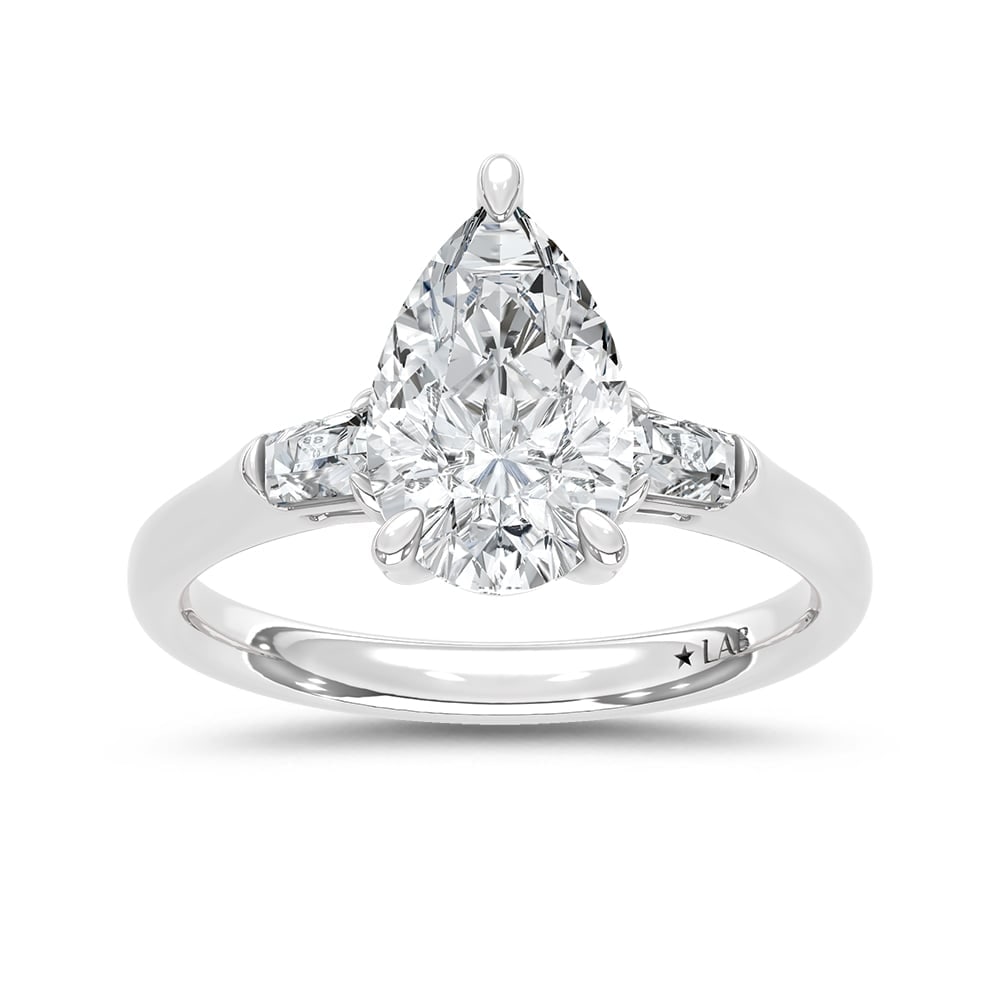 14K White Gold Lab Grown Diamond 2 1/6 Ct.Tw. Pear and Tapper Three Stone Engagement Ring: 14K White Gold Lab Grown Diamond 2 1/6 Ct.Tw. Pear and Tapper Three Stone Engagement Ring This stunning three-stone ring features a sparkling 2 CT Pear Center diamond with two shimmering side diamonds