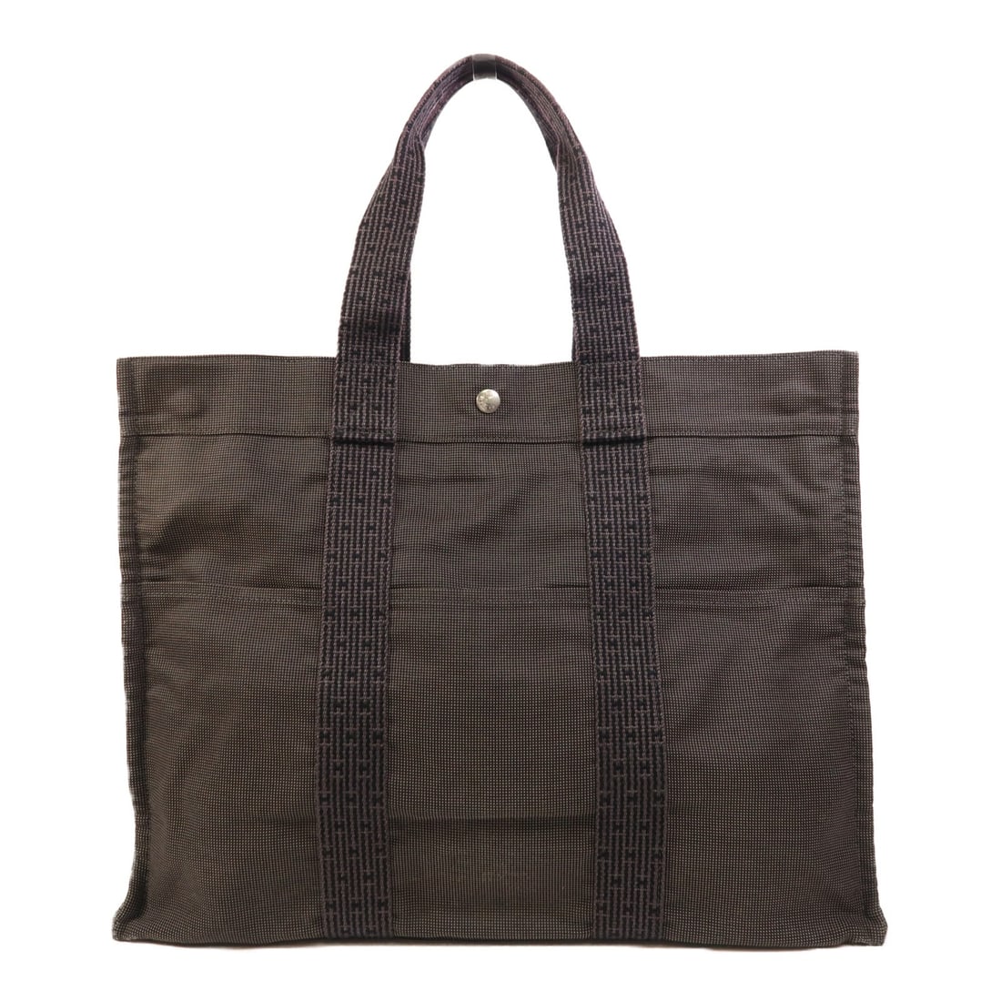 Hermes Herline Canvas Tote in Gray with Palladium Hardware: Hermes Herline Canvas Tote in Gray with Palladium Hardware This Hermes Herline tote bag features a grey canvas exterior with palladium hardware. It offers a spacious interior, making it suitable for e