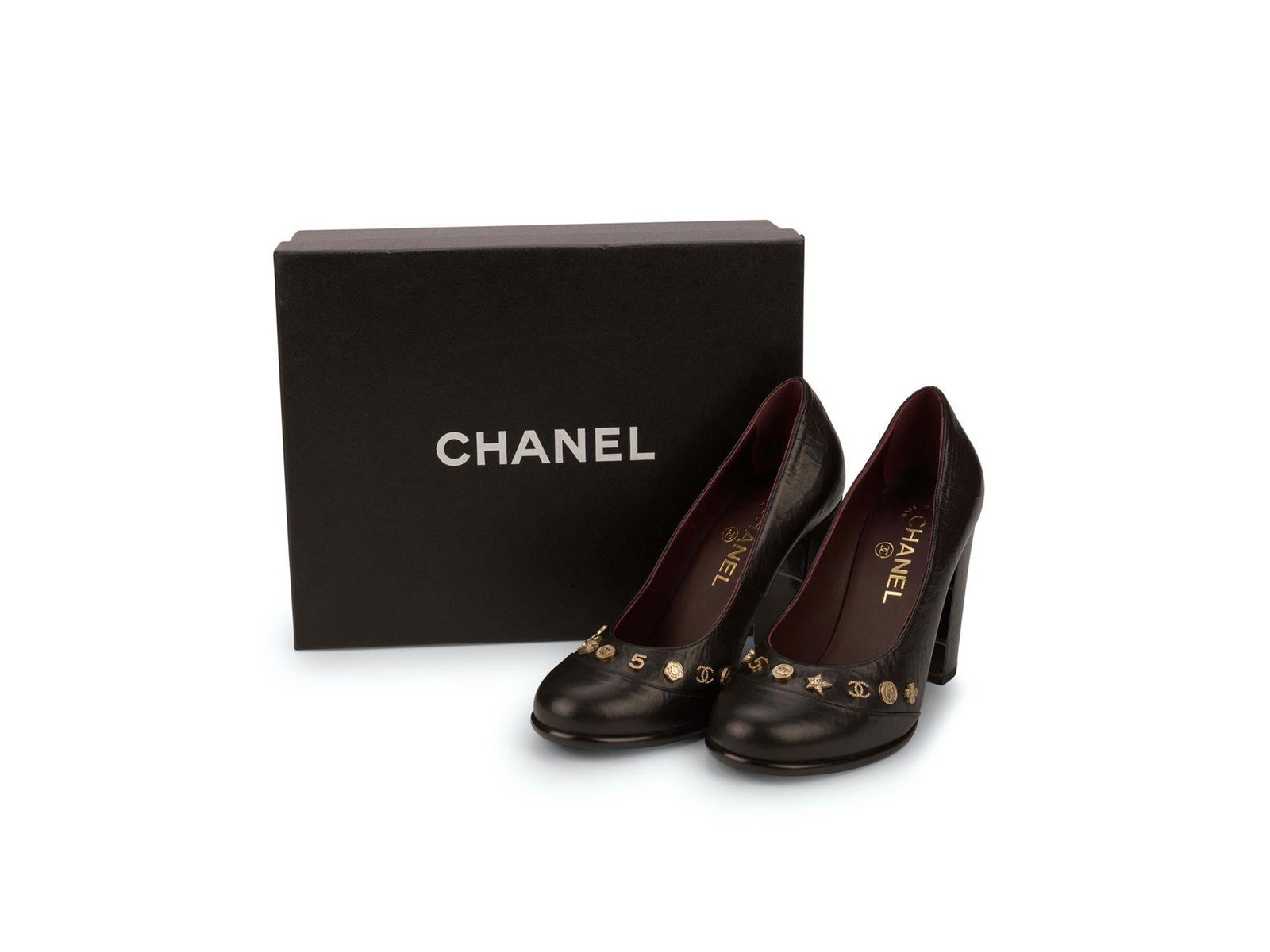 Chanel NIB Black Calfskin Pumps with Icon Symbols: Chanel NIB Black Calfskin Pumps with Icon Symbols Discover the elegance of these brand new Chanel black pumps, crafted from luxurious calfskin leather. Adorned with striking gold tone icon symbols, th