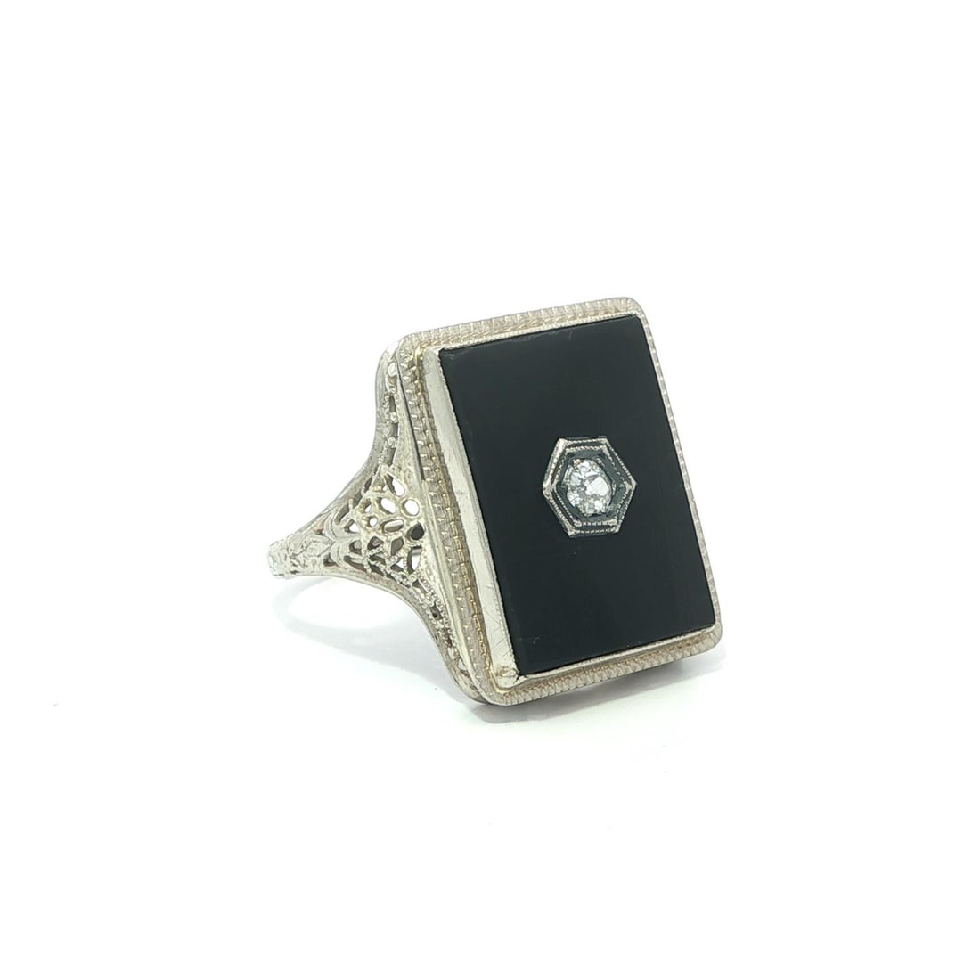 14k White Gold Filigree Ring with Black Onyx and Old Mine Cut Diamond: 14k White Gold Filigree Ring with Black Onyx and Old Mine Cut Diamond This antique cocktail ring features a rectangular black onyx stone, accented by an old mine cut natural diamond, all set in solid