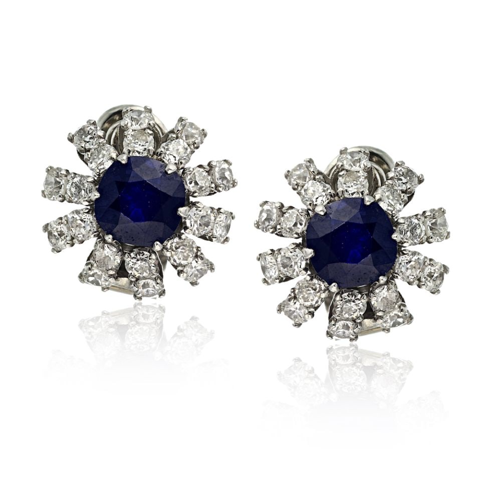 Platinum Art Deco Earrings with Sapphire and Diamond Accents: Platinum Art Deco Earrings with Sapphire and Diamond Accents These Art Deco earrings are crafted in platinum and feature cushion cut sapphires and diamonds. The earrings have an approximate total diam