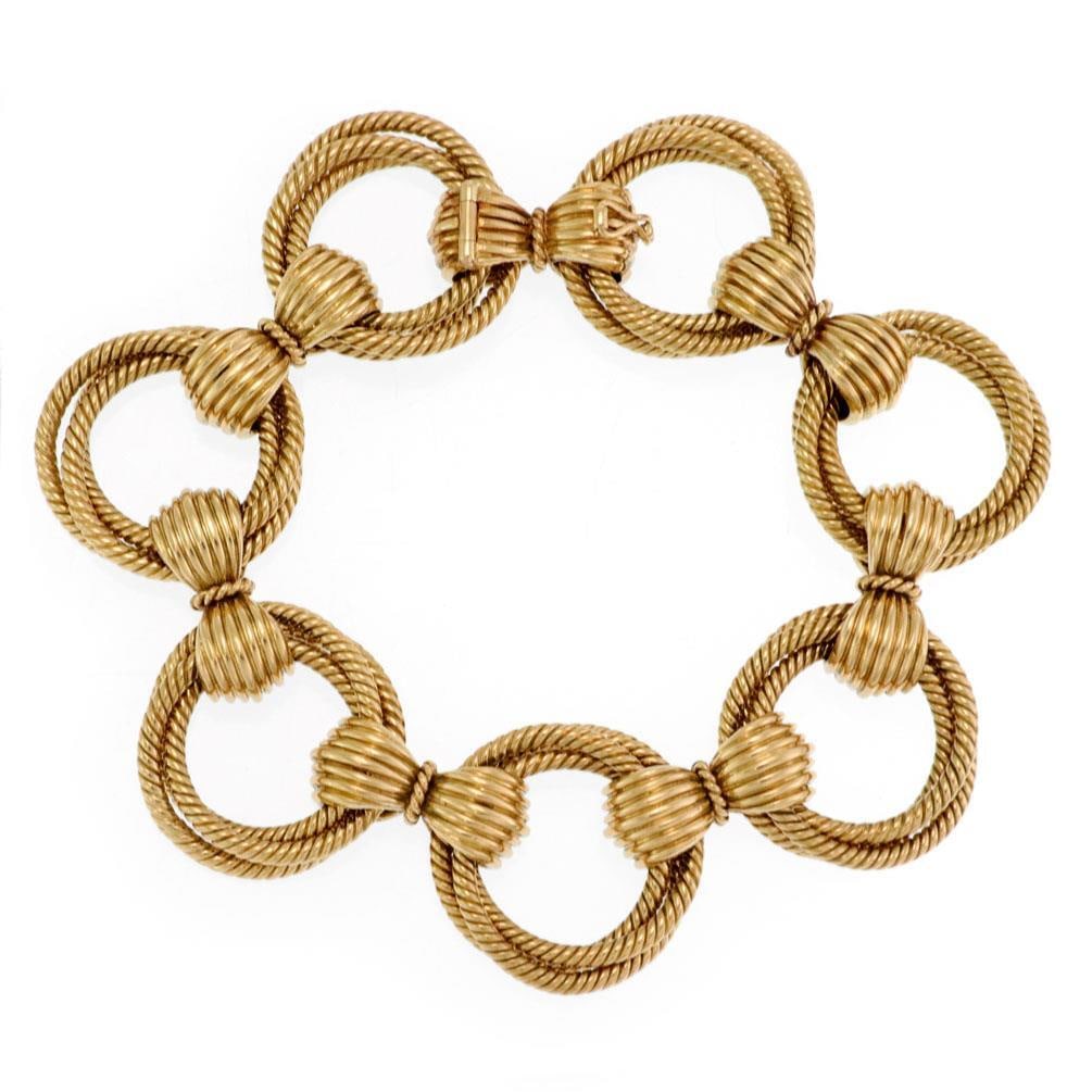 Estate 18k Yellow Gold Triple Cable Link Fancy Bracelet: Estate 18k Yellow Gold Triple Cable Link Fancy Bracelet This stunning bracelet showcases exquisite craftsmanship with its 18k yellow gold construction. It features a unique design of triple cable wire