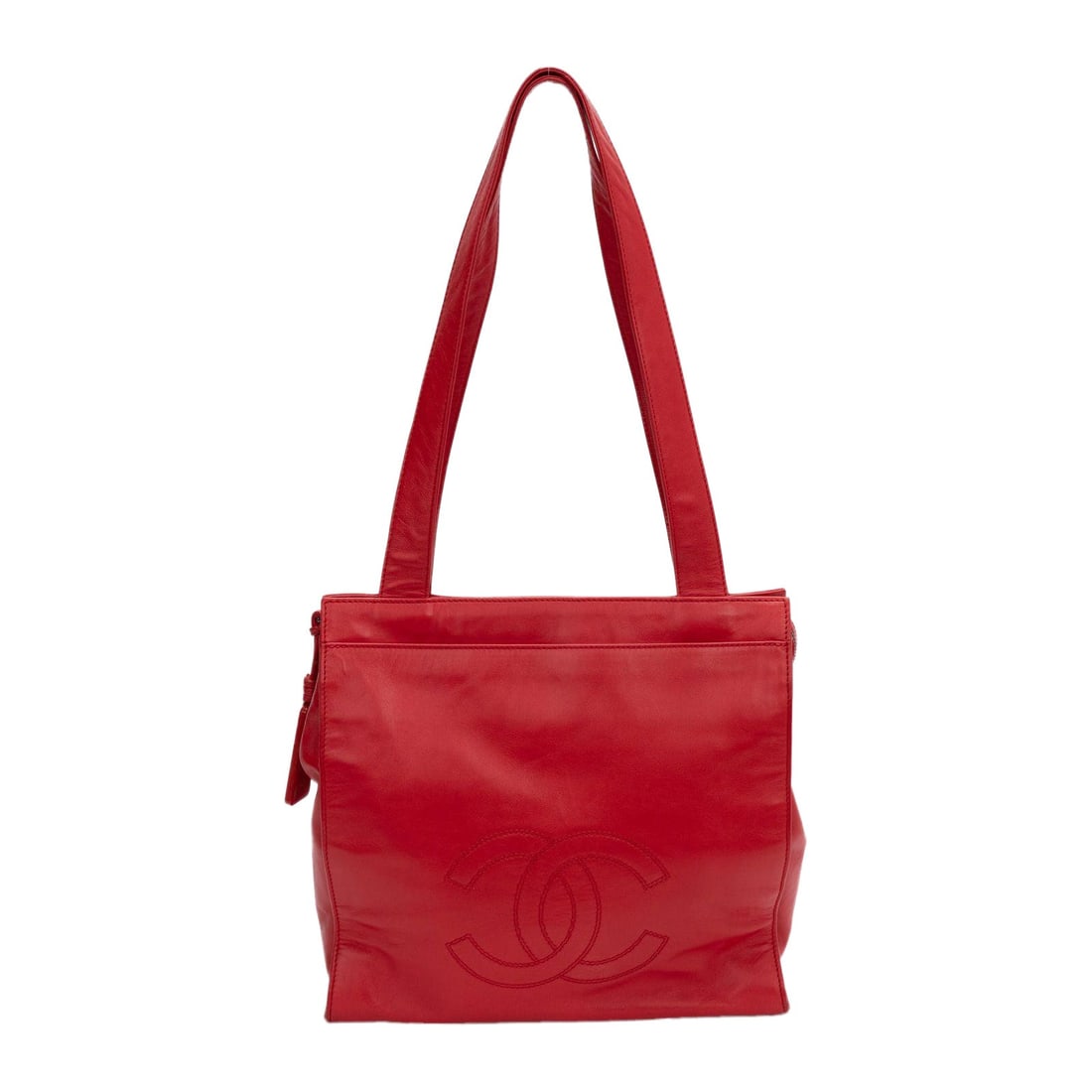 Chanel Vintage 90s Red Lambskin Tote Bag with CC Logo: Chanel Vintage 90s Red Lambskin Tote Bag with CC Logo This vintage Chanel tote bag, crafted from luxurious lambskin, is a stunning piece from the 90s, showcasing a bold red hue. The front of the bag f