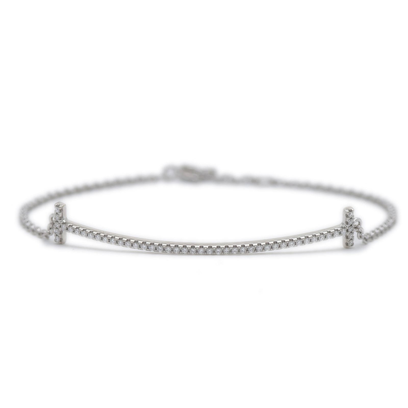 T Smile Necklace in White Gold by Tiffany & Co: T Smile Necklace in White Gold by Tiffany & Co This Tiffany & Co. T Smile bracelet is crafted from white gold and features a sleek silver finish. Designed for women, it measures 16.5 cm in length and