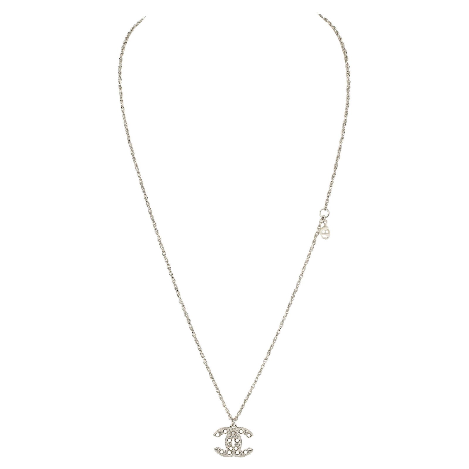 Chanel Silver CC Pendant Necklace with Round Cut Pearls 2022: Chanel Silver CC Pendant Necklace with Round Cut Pearls 2022 This exquisite Chanel necklace features a delicate silver tone design, showcasing a stunning CC pendant adorned with round cut pearls. Craf