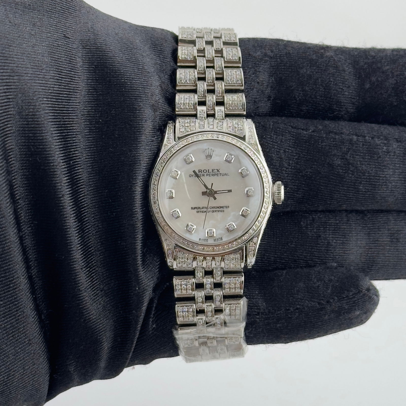 Ladies Rolex Datejust 6466 Aftermarket White MOP Dial Iced Jubilee Bracelet: Ladies Rolex Datejust 6466 Aftermarket White MOP Dial Iced Jubilee Bracelet This Rolex Datejust features a white mother of pearl aftermarket dial, a pave-set bezel, and an aftermarket iced-out Jubilee