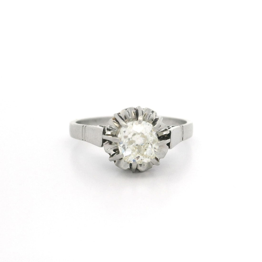 Antique Platinum 0.78ct Old Mine Cut Diamond Flower Ring: Antique Platinum 0.78ct Old Mine Cut Diamond Flower Ring This exquisite antique solitaire ring features a stunning 0.78ct old mine cut diamond, elegantly set in a unique illusion flower design. The di