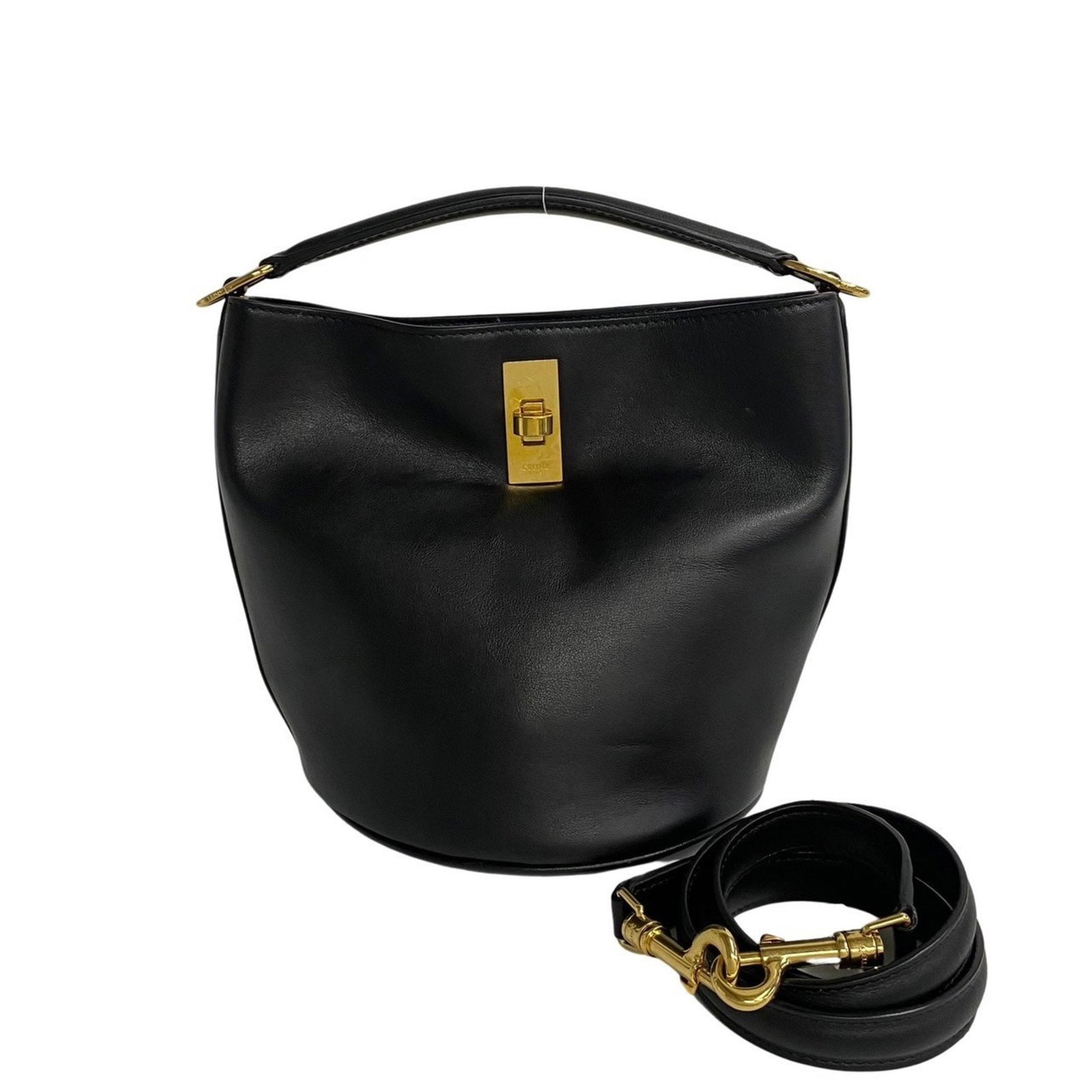 Black Leather Seau Bucket Bag by Celine France: Black Leather Seau Bucket Bag by Celine France This Celine Seau is a black leather bucket bag designed for women, showcasing the brand's signature minimalist style. Crafted in France, it features clea
