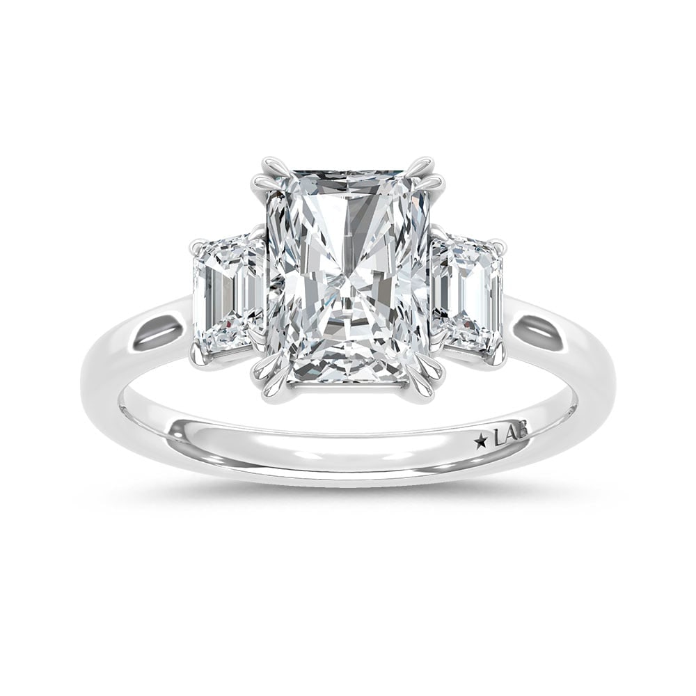 14K White Gold Lab Grown Diamond 2 Ct.Tw. Elongated Radiant Cut Three Stone Engagement Ring: 14K White Gold Lab Grown Diamond 2 Ct.Tw. Elongated Radiant Cut Three Stone Engagement Ring This stunning three-stone ring features a sparkling 1 1/2 CT Elongated Radiant Center diamond with two