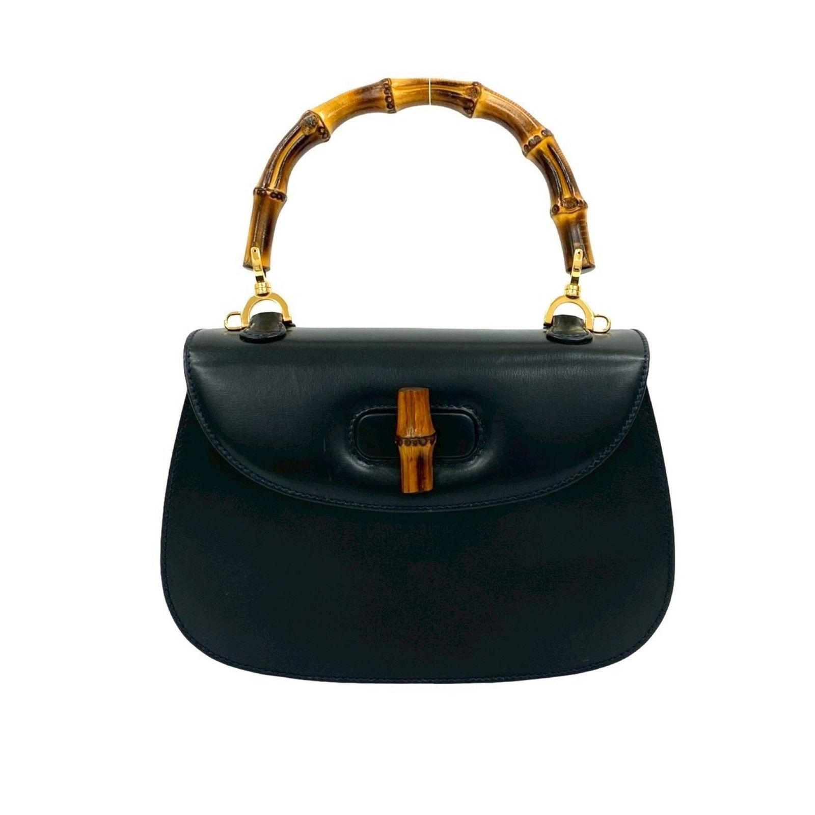 Navy Leather Gucci Bamboo Shoulder Bag Italy: Navy Leather Gucci Bamboo Shoulder Bag Italy This Gucci Bamboo handbag features a navy leather exterior and is designed for women. It offers a structured silhouette with the iconic bamboo detail. The