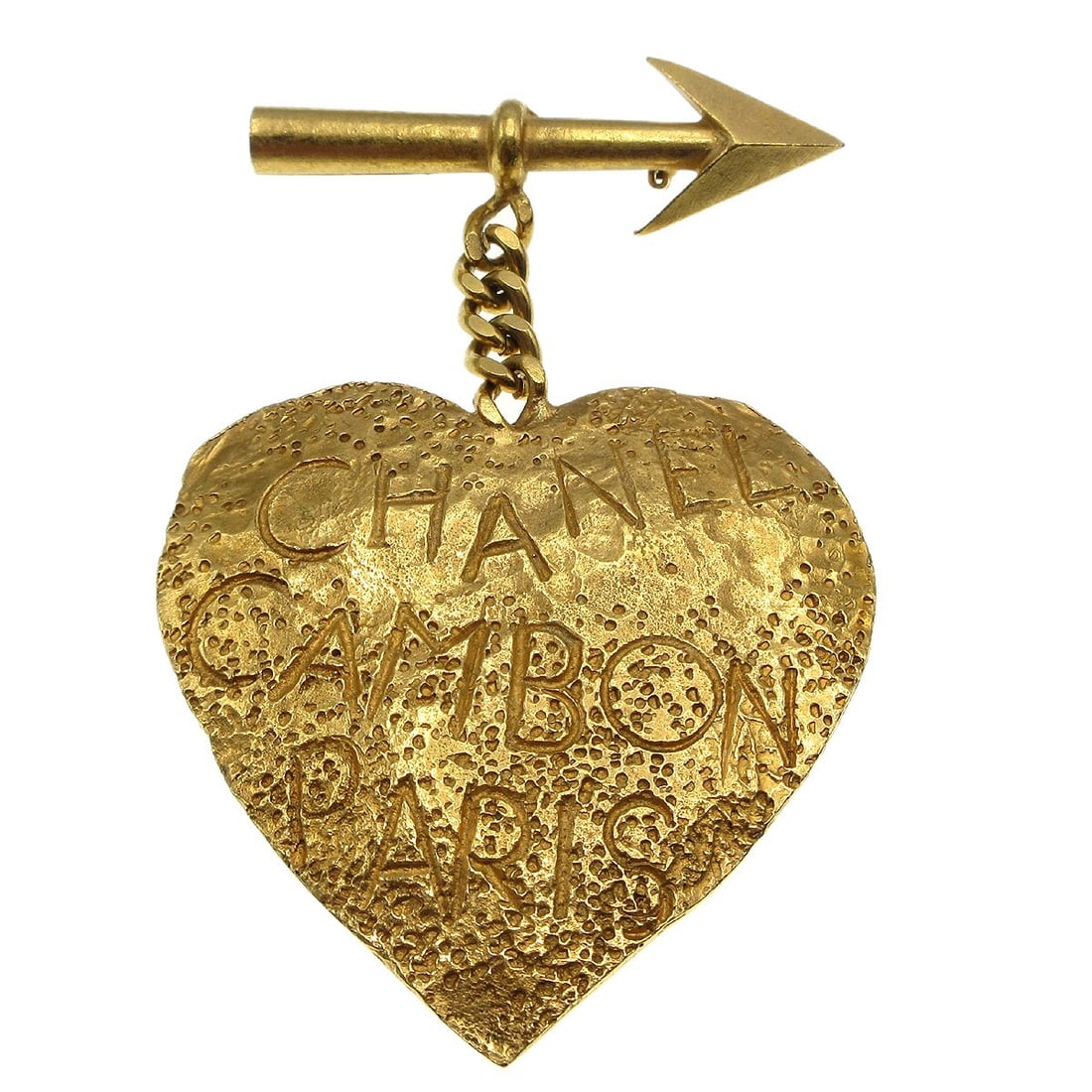 Vintage Chanel 93P Gold-tone Heart Arrow Brooch: Vintage Chanel 93P Gold-tone Heart Arrow Brooch This vintage Chanel brooch features a charming heart and arrow design, crafted in a luxurious gold-tone finish. The piece showcases reasonable wear and