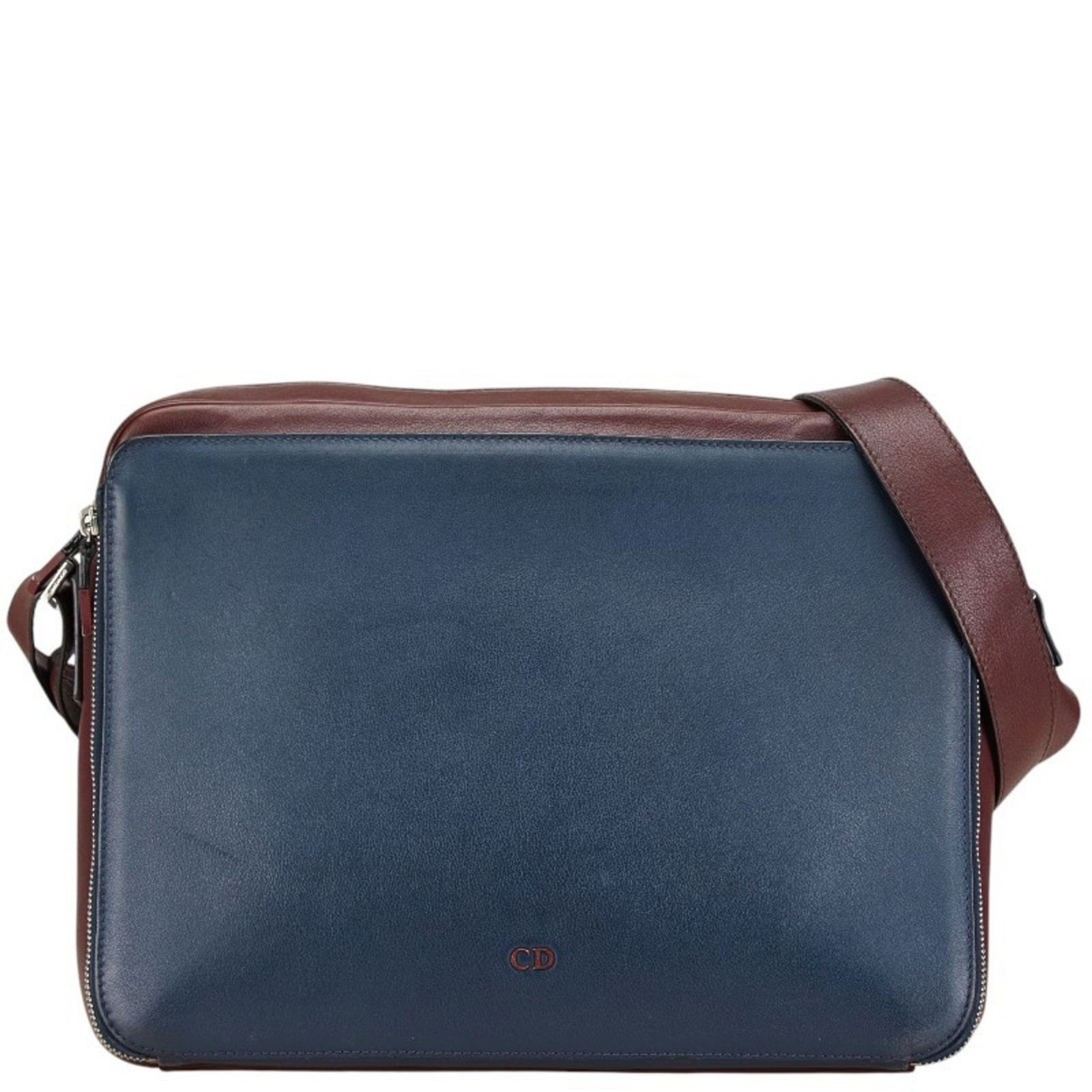Navy Leather Dior CD Bag 27.5cm x 34cm x 7.5cm Italy: Navy Leather Dior CD Bag 27.5cm x 34cm x 7.5cm Italy This Dior CD bag features a sleek navy leather exterior, offering a sophisticated and versatile look. The bag shows slight signs of use, with minor
