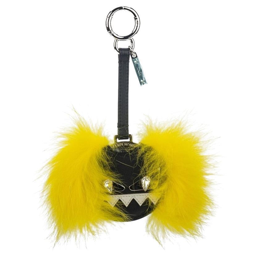 Fendi New Monster Key Ring Leather with Yellow Fur: Fendi New Monster Key Ring Leather with Yellow Fur Add a playful touch to your keys or bag with the Fendi New Monster Key Ring. This unique accessory features a striking design made from premium leath