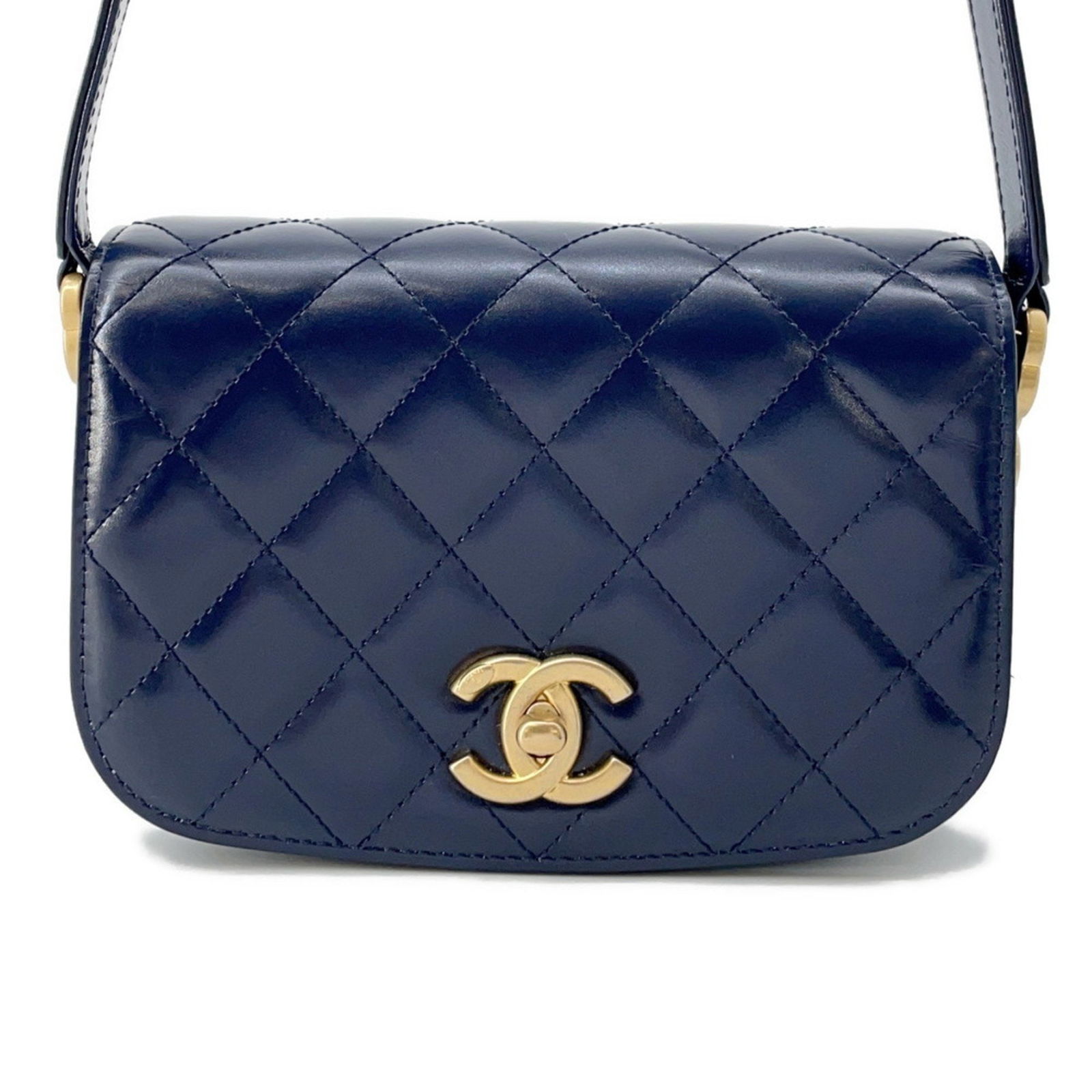 Navy Patent Leather Full Flap Bag by Chanel: Navy Patent Leather Full Flap Bag by Chanel This Chanel Full Flap handbag is crafted from navy patent leather and features a classic, structured silhouette. The bag includes metal fittings and is desi