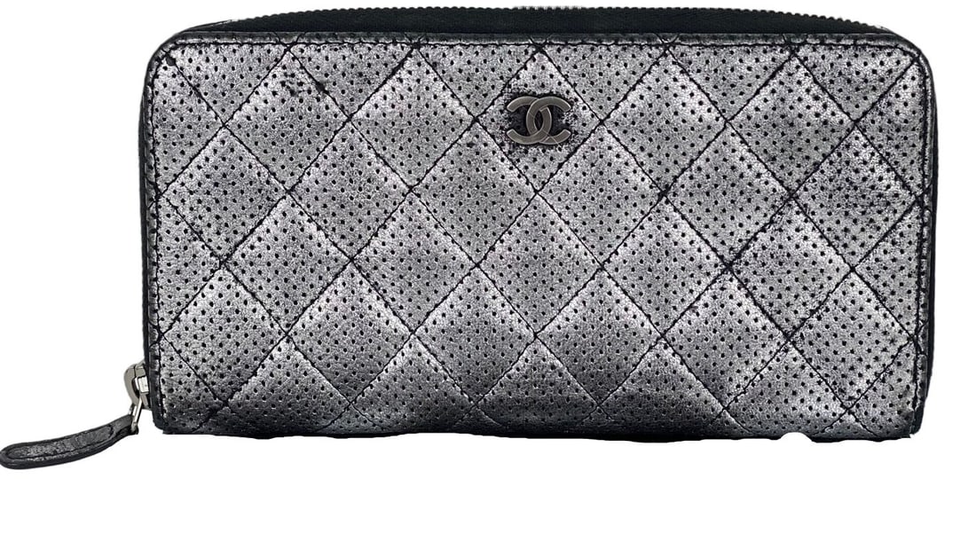Chanel Quilted Perforated Silver Metallic Zip-Around Wallet: Chanel Quilted Perforated Silver Metallic Zip-Around Wallet This stylish Chanel wallet features a quilted perforated design crafted from metallic lambskin leather. The zip-around style offers practica