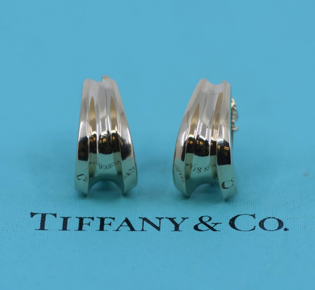 Tiffany & Co 14K Yellow Gold Stud Earrings with Pouch: Tiffany & Co 14K Yellow Gold Stud Earrings with Pouch Elevate your jewelry collection with these stunning Tiffany & Co. 14K Yellow Gold Earrings. Crafted from high-quality yellow gold, these elegant s