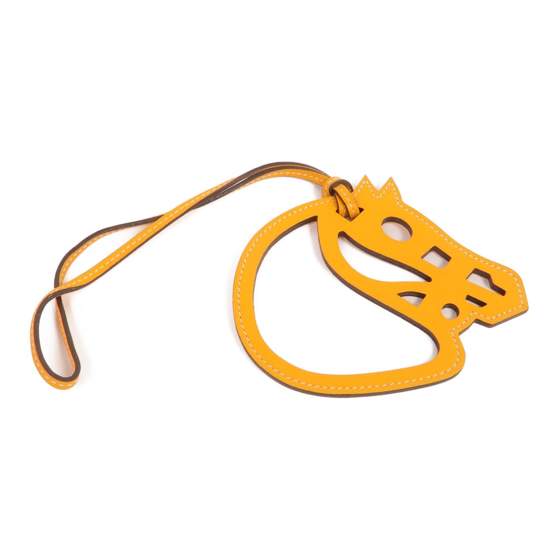 HERMES Paddock Cheval Charm Orange Calfskin Leather: HERMES Paddock Cheval Charm Orange Calfskin Leather Introducing the HERMES Paddock Cheval Charm, crafted from premium calfskin leather in a vibrant orange hue. This charming accessory adds a touch of