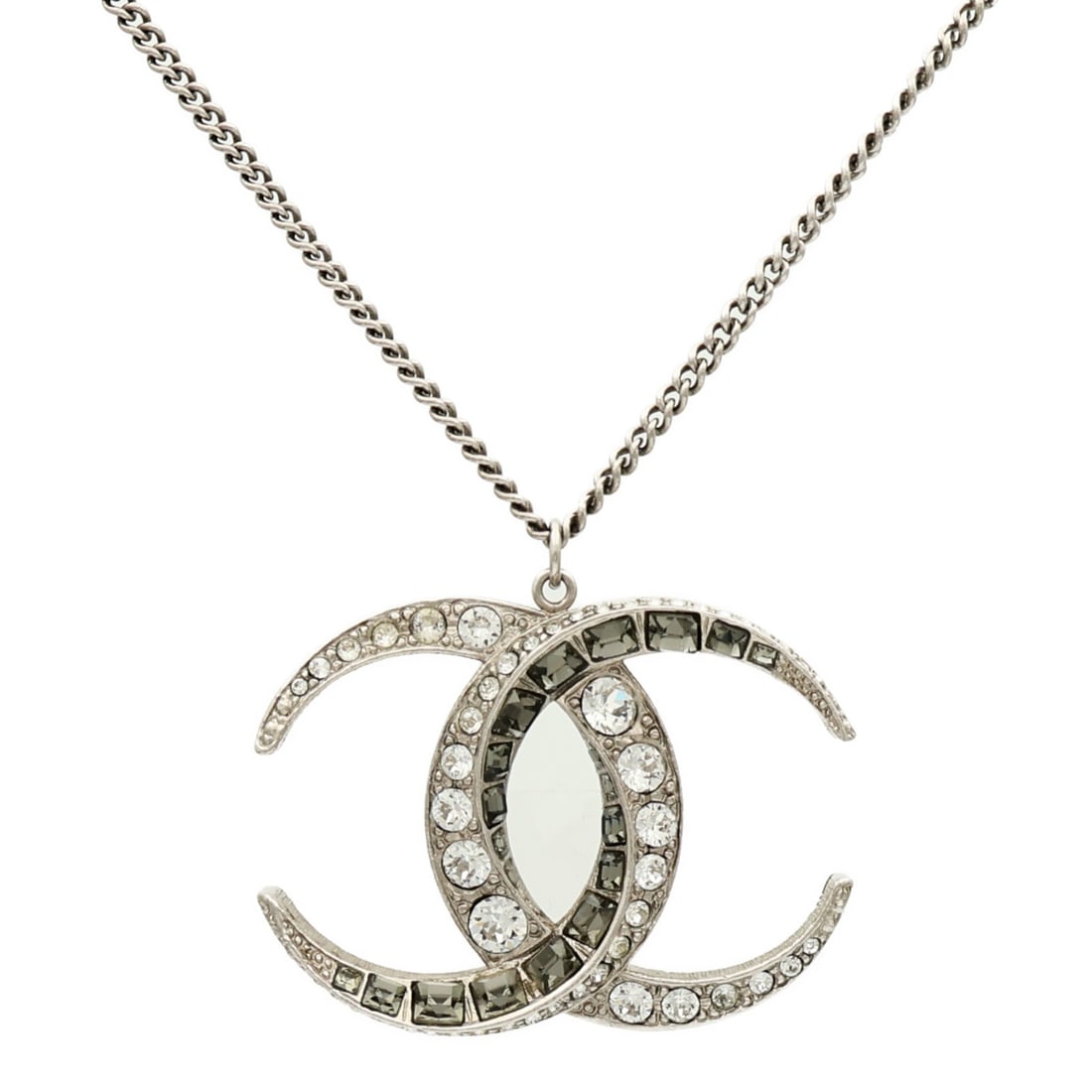 Silver Metal Necklace with CC Motif by CHANEL: Silver Metal Necklace with CC Motif by CHANEL This CHANEL necklace features the iconic CC logo in a silver-tone metal. Made in France, the necklace does not include any stones and is designed in a reg