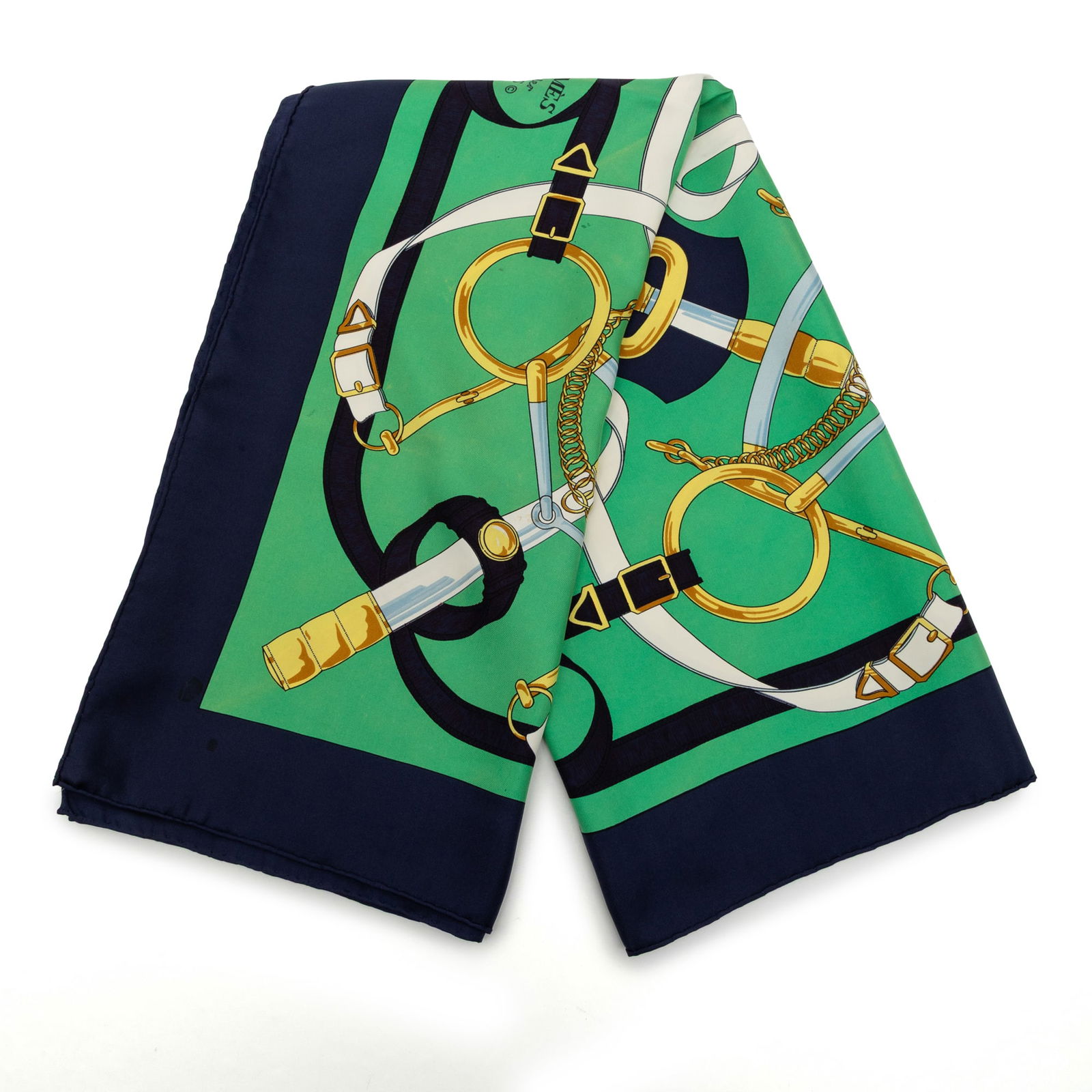 Eperon D Or green silk scarf by Hermes 90cm: Eperon D Or green silk scarf by Hermes 90cm This Hermes Eperon D'Or scarf features the iconic equestrian-inspired print in green on 100% silk. Crafted in France, this accessory is designed for a sophi