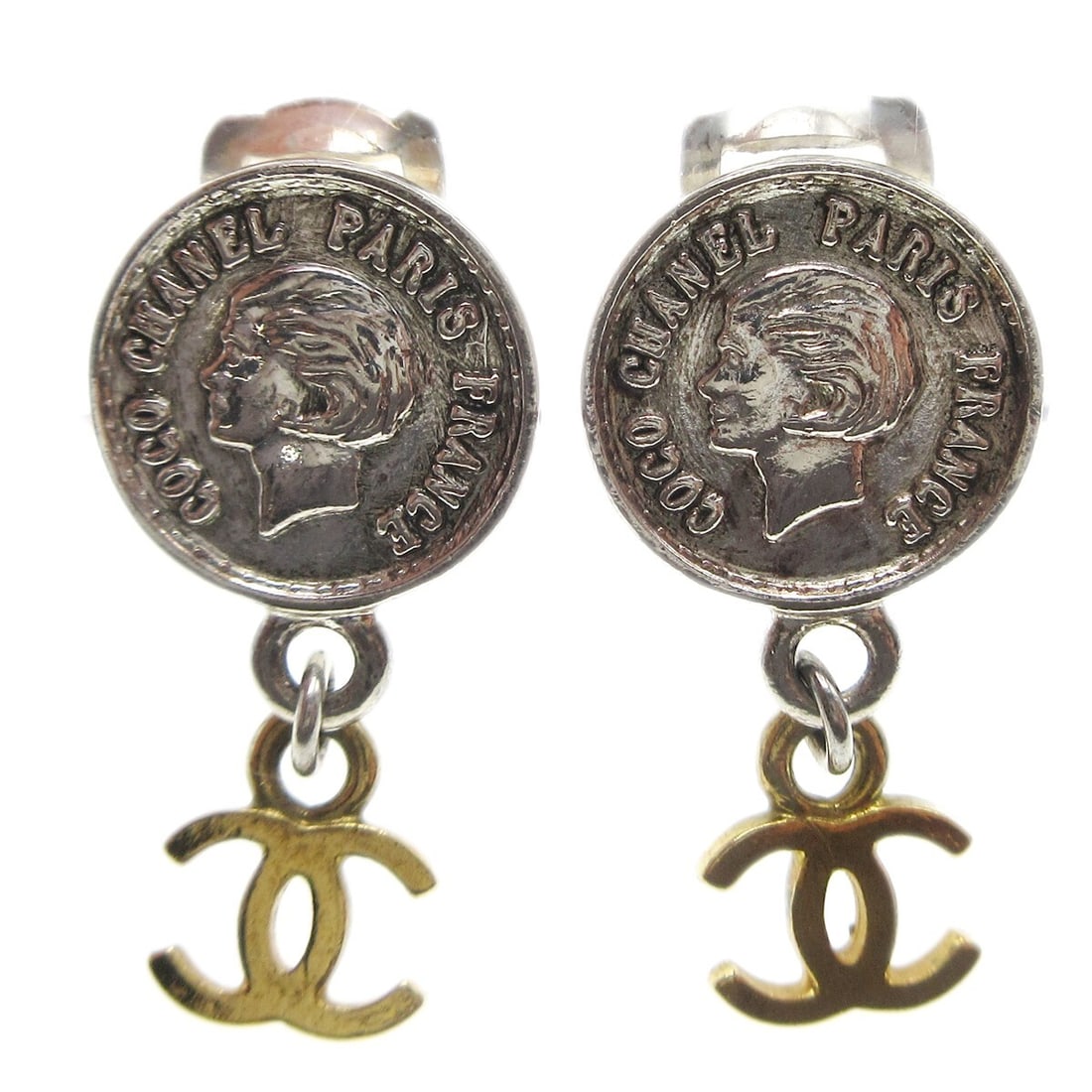 Chanel 97P Gold Silver Medallion Charm Dangle Clip-On Earrings: Chanel 97P Gold Silver Medallion Charm Dangle Clip-On Earrings Elevate your accessory game with these stunning Chanel Medallion Charm Dangle Earrings. Crafted with a luxurious combination of gold and