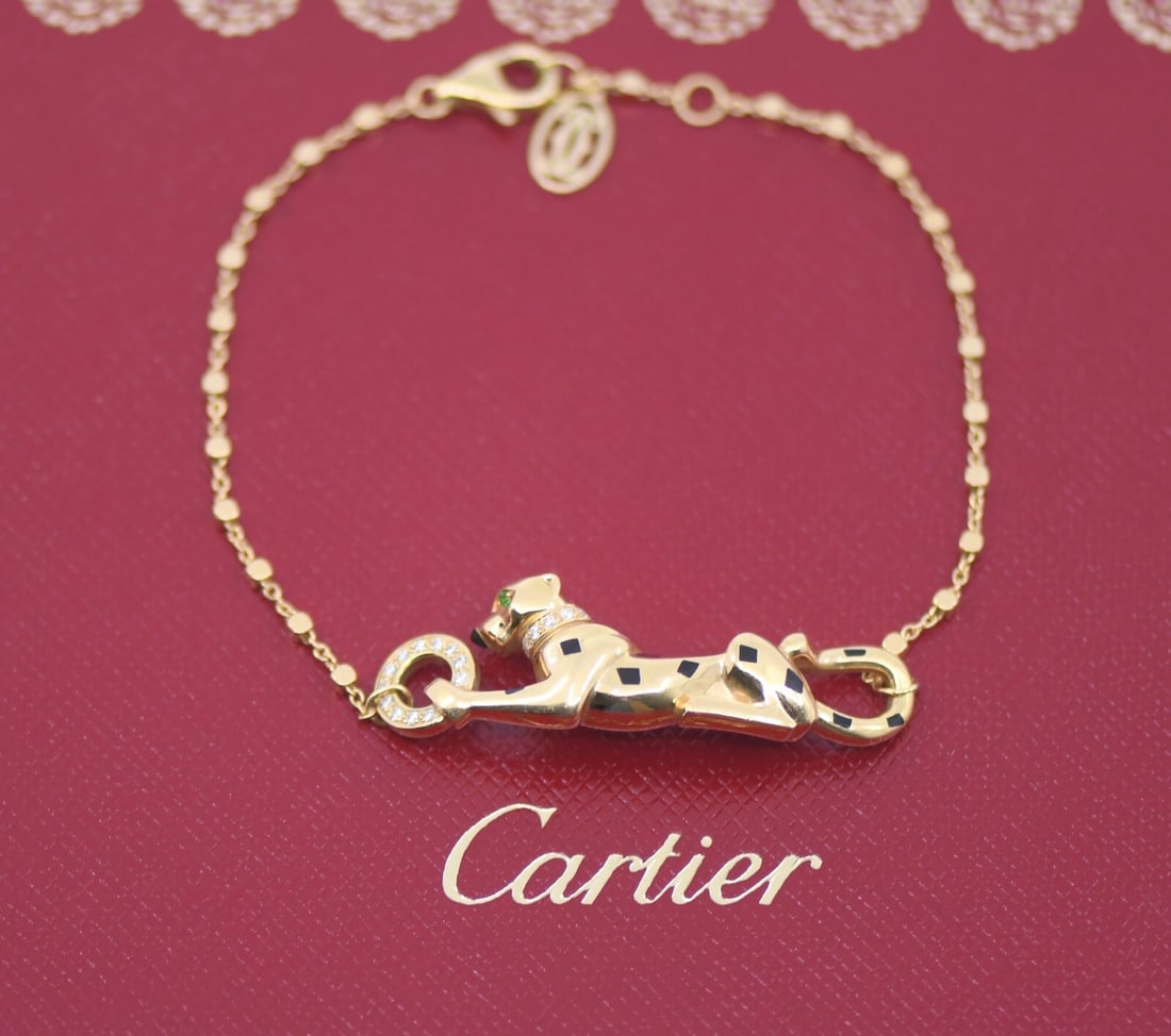 Cartier Panthere 18K Yellow Gold Bracelet with Tsavorite Gemstone: Cartier Panthere 18K Yellow Gold Bracelet with Tsavorite Gemstone This stunning Cartier Panthere bracelet is crafted from high-quality 18K yellow gold, showcasing a luxurious chain style that perfectl
