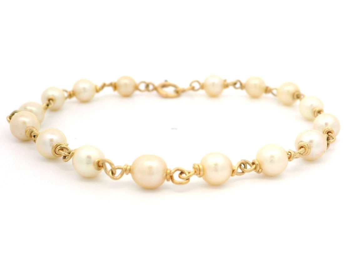 Vintage 14k Yellow Gold Wire Bracelet with Cultured Pearls: Vintage 14k Yellow Gold Wire Bracelet with Cultured Pearls Elevate your accessory collection with this exquisite Vintage Handmade 14k Yellow Gold Wire Cultured Pearl Bracelet. Featuring 16 genuine rou