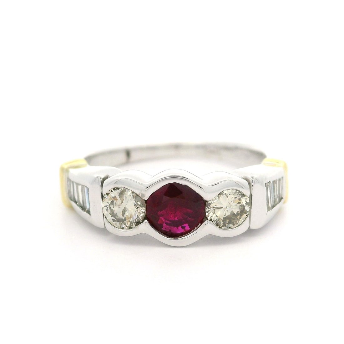 18k Two Tone Gold 1.32ct Ruby and Baguette Diamond Band Ring: 18k Two Tone Gold 1.32ct Ruby and Baguette Diamond Band Ring This exquisite 18k Two Tone Gold Band Ring features a stunning arrangement of gemstones designed to captivate. At its center lies a natural
