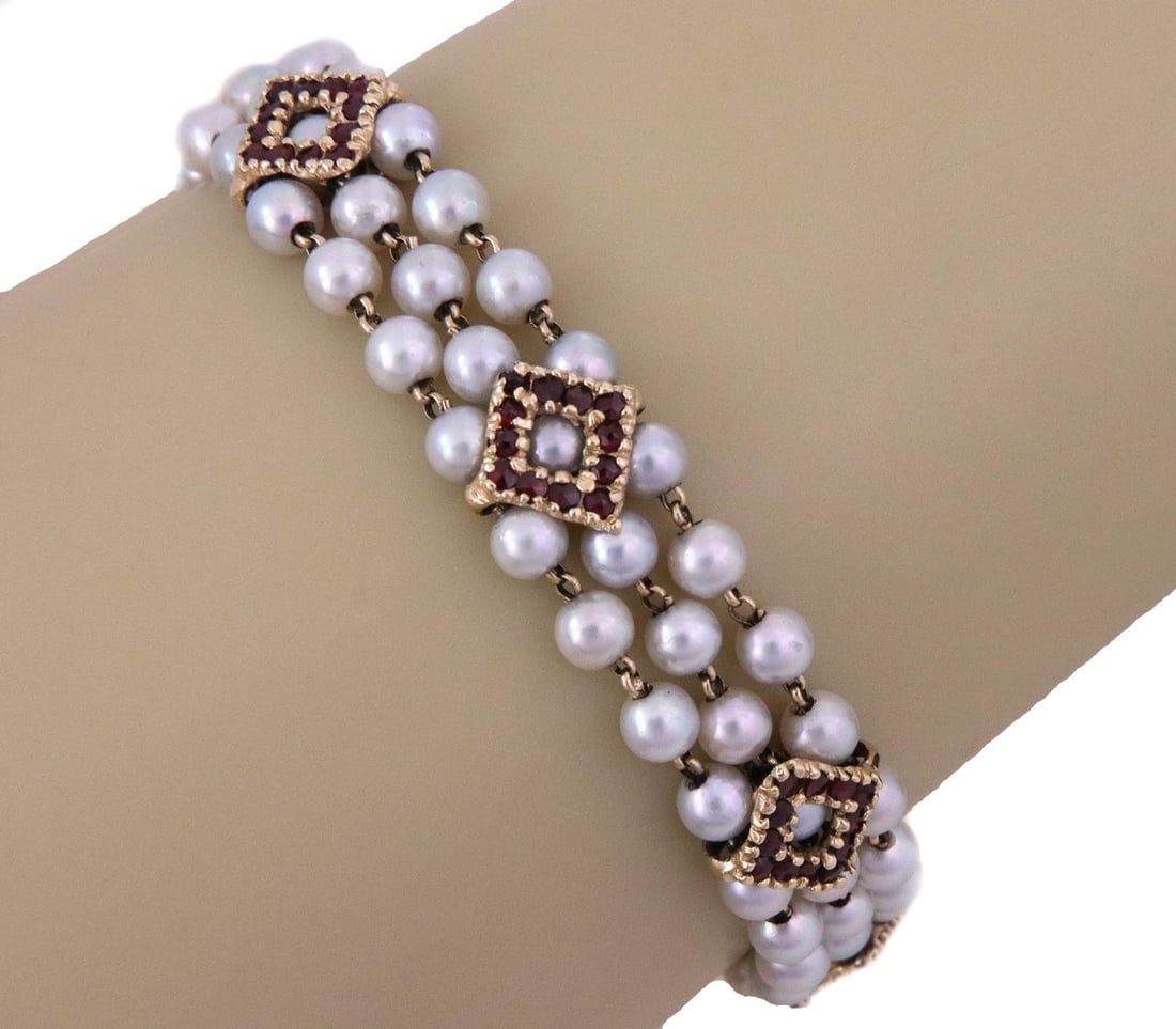 Lucien Piccard Vintage 14k Gold Ruby Pearl Triple Strand Bracelet: Lucien Piccard Vintage 14k Gold Ruby Pearl Triple Strand Bracelet This exquisite vintage bracelet by Lucien Piccard showcases a stunning design crafted from 14k yellow gold. It features a triple stran