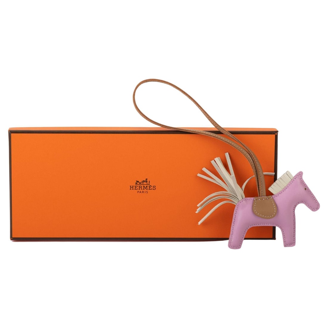 Hermes Rodeo Grigi Small Charm Mauve Sesame NIB: Hermes Rodeo Grigi Small Charm Mauve Sesame NIB Introducing the exquisite Hermes Rodeo Grigi Small Charm, crafted in a stunning combination of mauve sylvestre, craie, and sesame. This elegant piece is