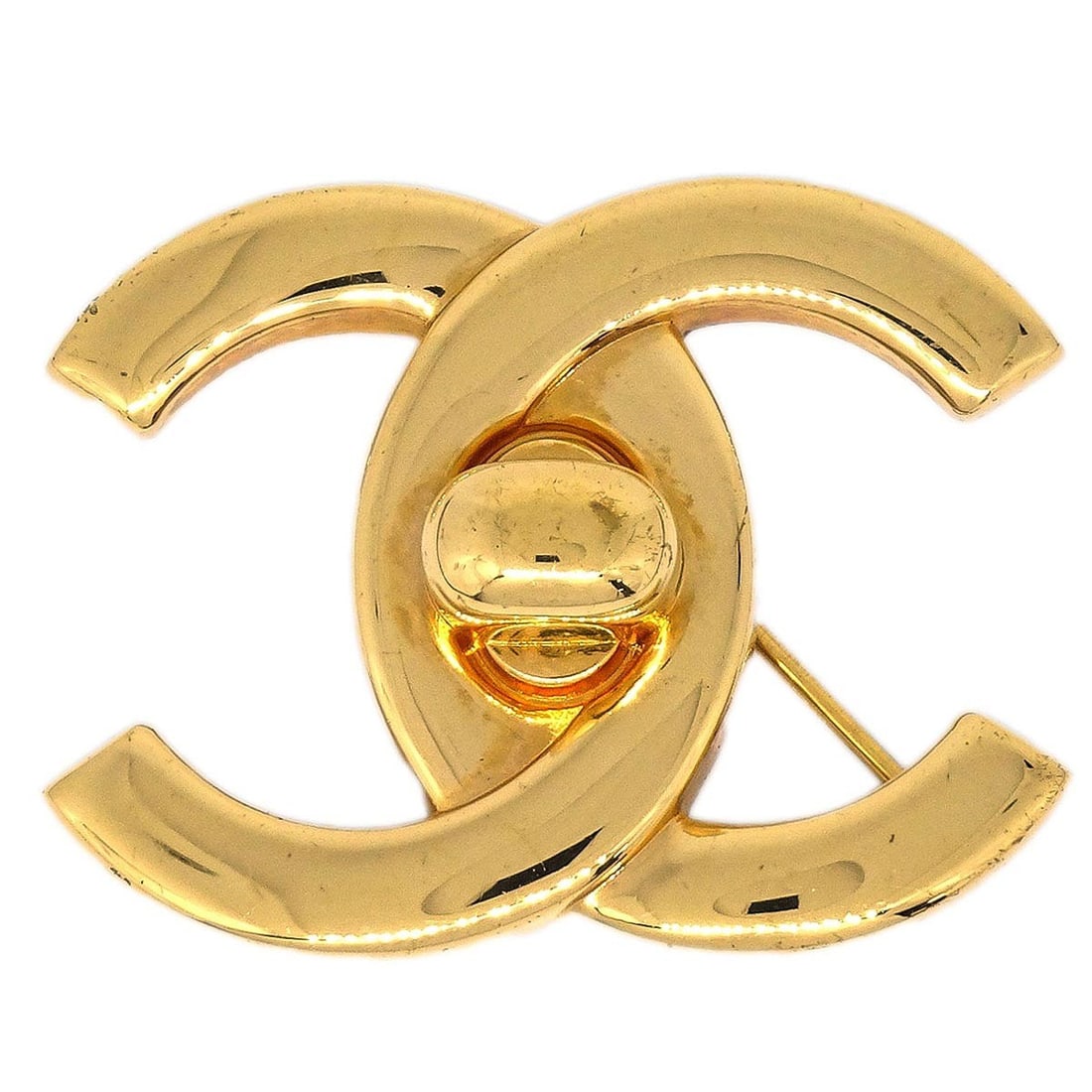 Large Gold Tone Chanel Logo Turnlock Brooch Pin 96A: Large Gold Tone Chanel Logo Turnlock Brooch Pin 96A This Chanel brooch features a large turnlock design in gold-tone metal, showcasing the iconic logo motif. Crafted in France, it offers a stylish acc