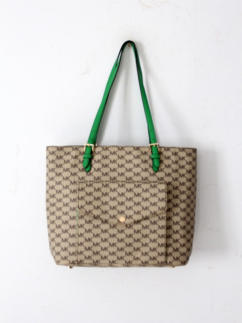 Michael Kors Monogram Tote Bag Green Leather Handles Gold Tone Accents: Michael Kors Monogram Tote Bag Green Leather Handles Gold Tone Accents Elevate your style with this Michael Kors Monogram Canvas Tote Bag, showcasing the iconic MK monogram pattern crafted in coated c