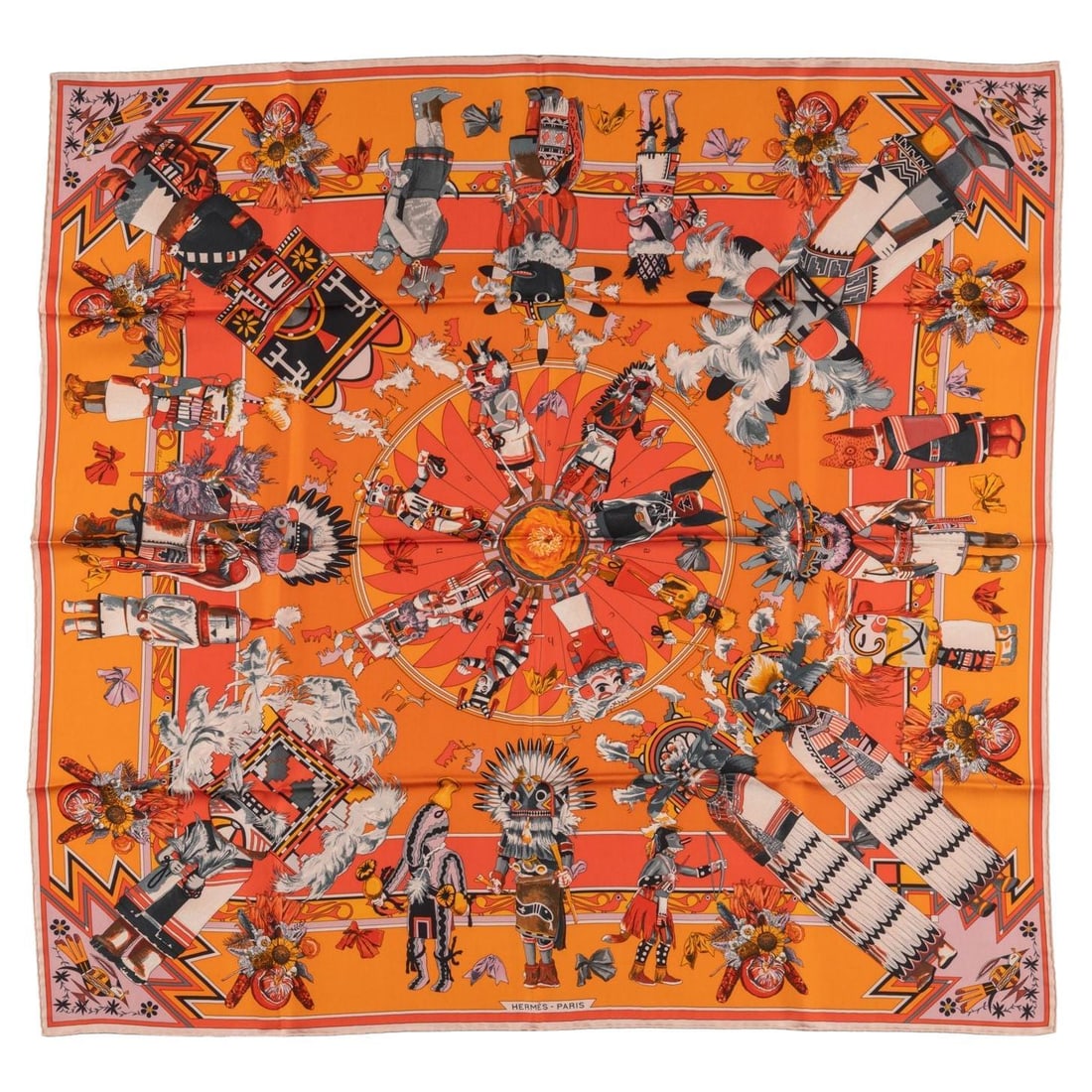 Hermes Kachinas Silk Scarf 35 in Orange by Kermit Oliver: Hermes Kachinas Silk Scarf 35 in Orange by Kermit Oliver The Hermes "Kachinas" Silk Scarf is a luxurious accessory crafted in France, showcasing a vibrant orange hue designed by Kermit Oliver. This ex