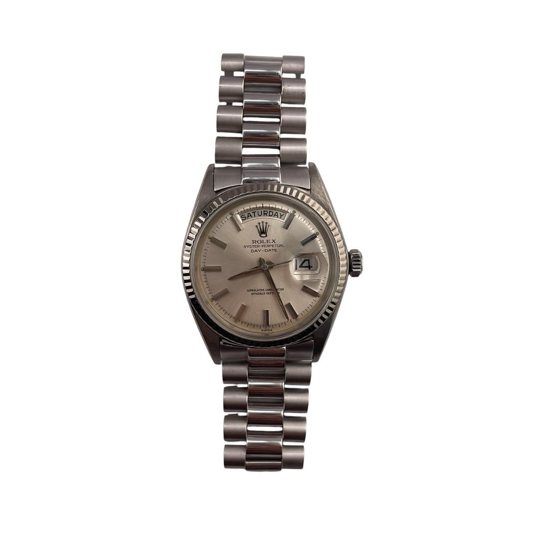 Men's Day-Date Silver Stick Dial Watch Reference 1803 with Aftermarket President Bracelet: Men's Day-Date Silver Stick Dial Watch Reference 1803 with Aftermarket President Bracelet This Rolex Day-Date features a silver stick dial and a fluted bezel, complemented by an Aftermarket President