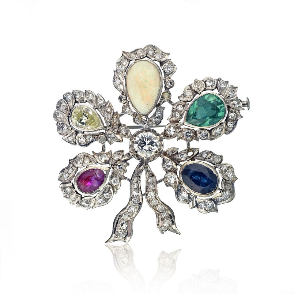 Vintage Platinum Flower Brooch with Emerald Ruby Sapphire Diamond Opal: Vintage Platinum Flower Brooch with Emerald Ruby Sapphire Diamond Opal This exquisite vintage flower brooch features a stunning array of multi-colour gemstones including an emerald, ruby, sapphire, di