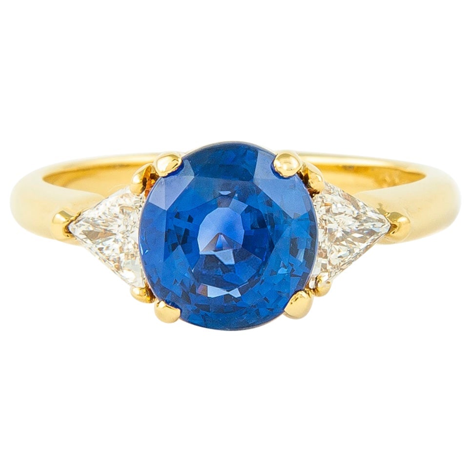 AGL Certified 3.14ct No Heat Burmese Sapphire Diamond Ring: AGL Certified 3.14ct No Heat Burmese Sapphire Diamond Ring This exquisite three-stone ring showcases a stunning 3.14 ct Burmese sapphire, certified by AGL as no heat, surrounded by two brilliant trill