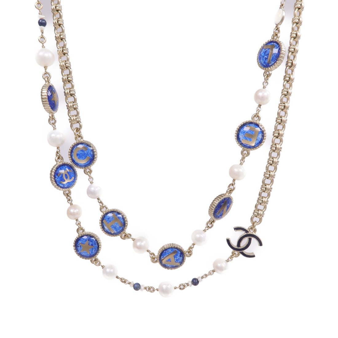 Gold Tone CC Pendant Necklace by CHANEL in Blue and White: Gold Tone CC Pendant Necklace by CHANEL in Blue and White This CHANEL necklace features a gold-tone finish with blue and white detailing. Designed in France, it displays the iconic CC logo and is craf