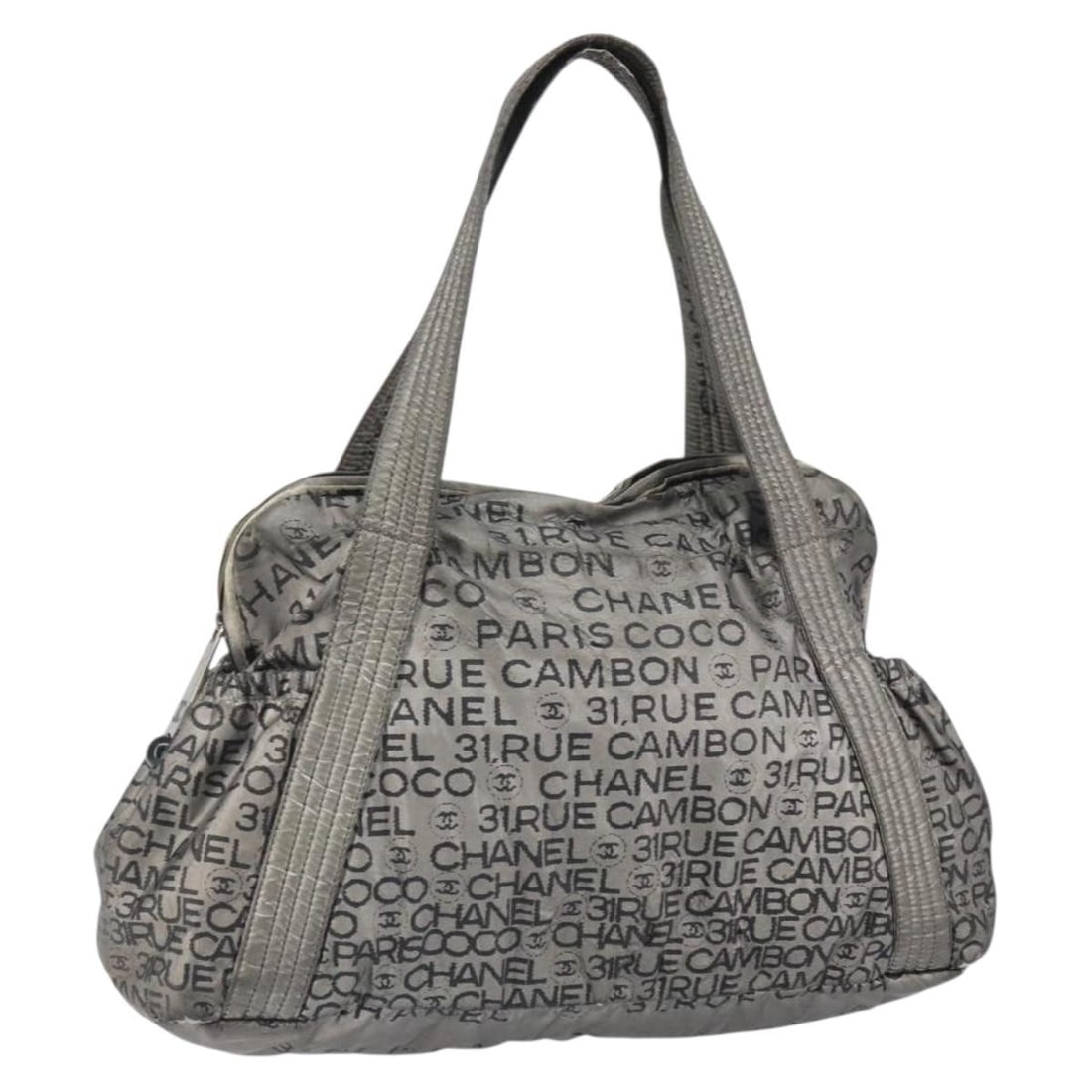 Chanel Unlimited Silver Nylon Tote Bag with CC Logo and Guarantee Card: Chanel Unlimited Silver Nylon Tote Bag with CC Logo and Guarantee Card This CHANEL Unlimited tote bag features a silver nylon exterior with the iconic CC logo accents. Designed with practicality in mi