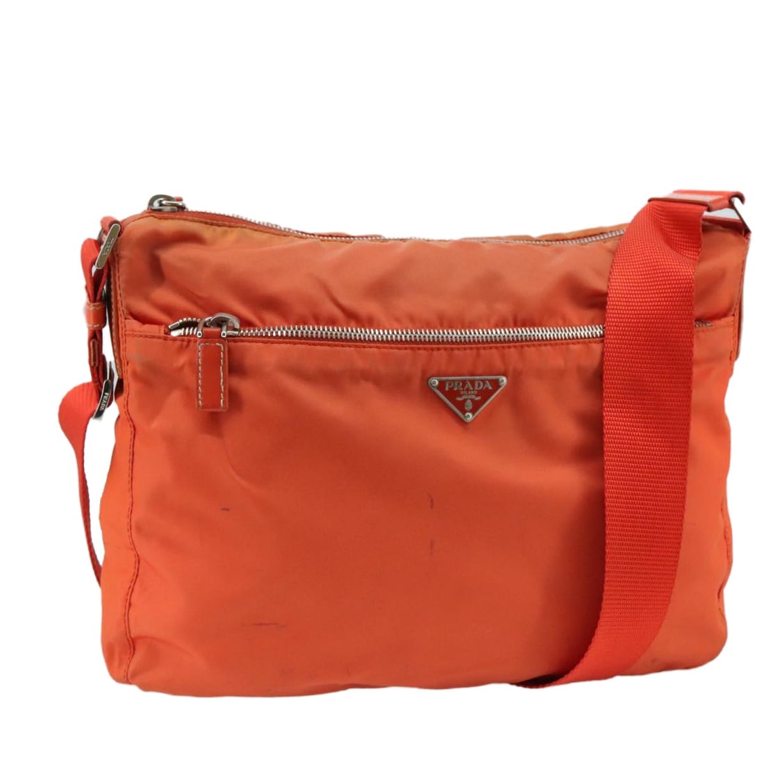 PRADA Nylon Shoulder Bag Orange Silver Made in Italy: PRADA Nylon Shoulder Bag Orange Silver Made in Italy This authentic PRADA shoulder bag showcases a vibrant orange nylon exterior complemented by silver accents. Crafted in Italy, it features a stylish