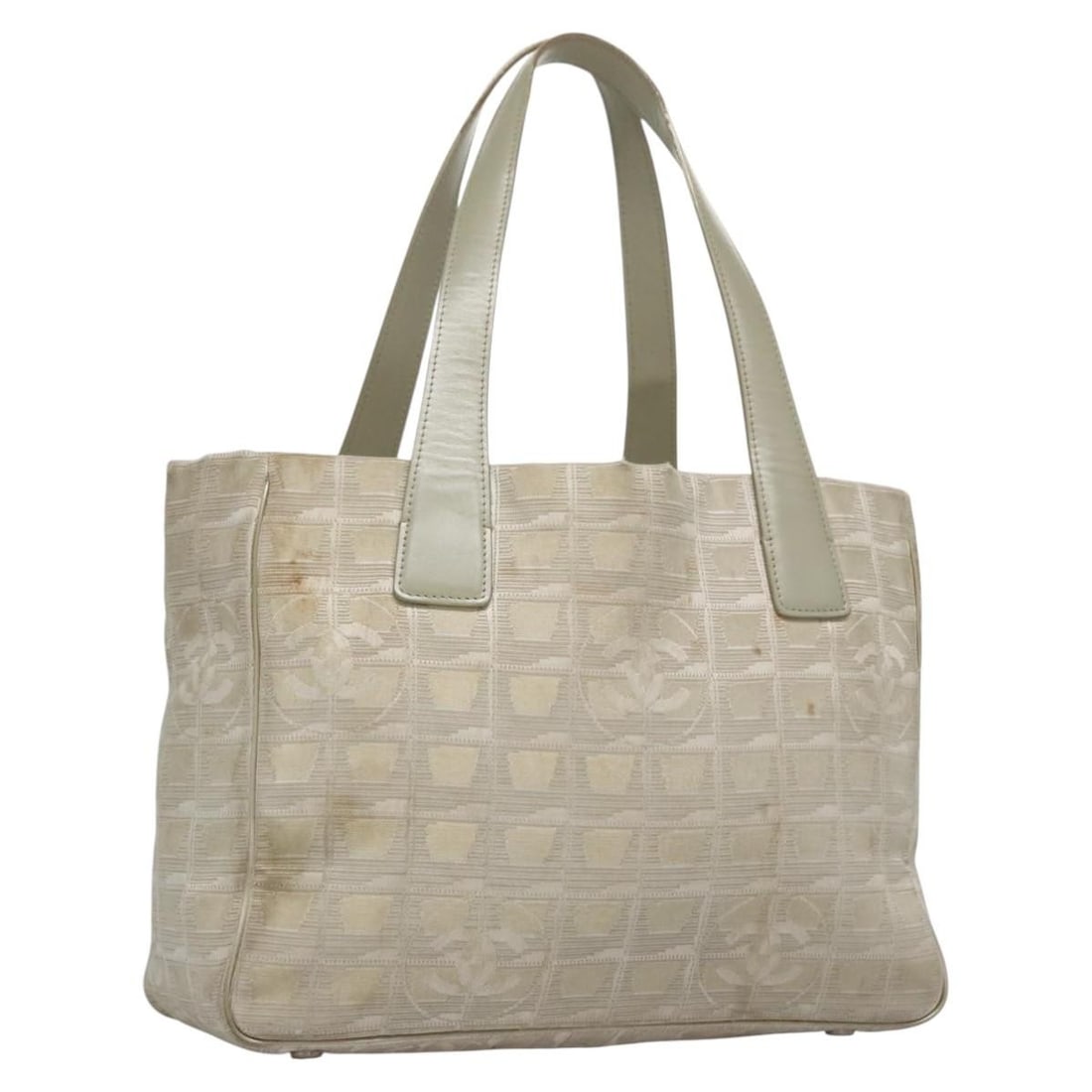 CHANEL Beige Canvas Tote Bag New Travel Line Made in Italy: CHANEL Beige Canvas Tote Bag New Travel Line Made in Italy This CHANEL tote bag is part of the iconic travel line, crafted in Italy from durable canvas in a stylish beige hue. The bag features a spaci