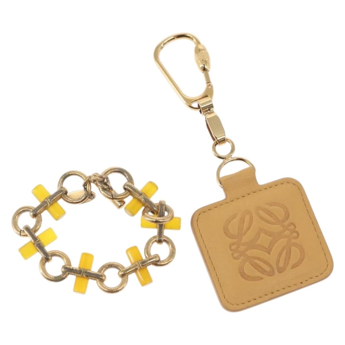 LOEWE Beige Gold Charm Leather Set of 2 Authentic: LOEWE Beige Gold Charm Leather Set of 2 Authentic This LOEWE Charm set features a distinctive combination of beige leather and gold metal accents, showcasing the brand's iconic craftsmanship. The exte