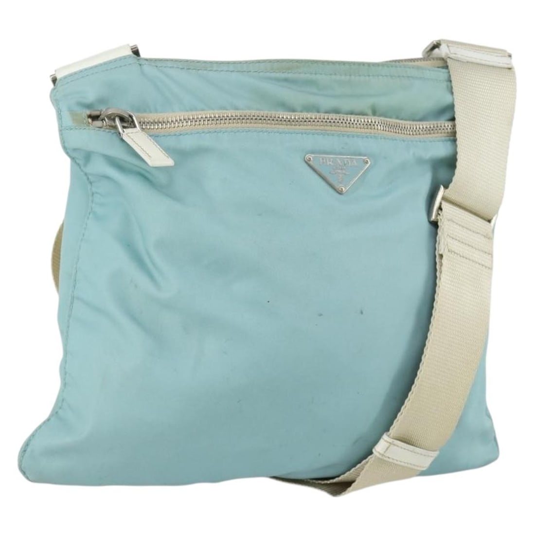 Light Blue Nylon PRADA Shoulder Bag Silver Hardware Italy: Light Blue Nylon PRADA Shoulder Bag Silver Hardware Italy This PRADA shoulder bag is crafted from light blue nylon with silver-tone accents. Made in Italy, it features an adjustable shoulder strap and