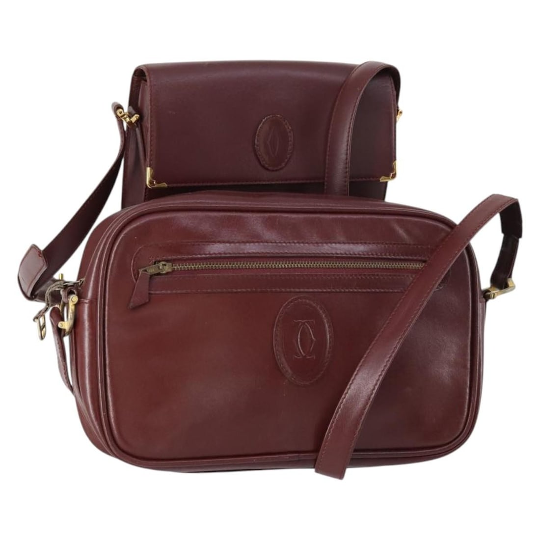 CARTIER Bordeaux Leather Must Line Shoulder Bag Set of 2 Auth: CARTIER Bordeaux Leather Must Line Shoulder Bag Set of 2 Auth This elegant CARTIER Must Line Shoulder Bag is crafted from high-quality leather in a rich bordeaux color. Made in Spain, this stylish bag