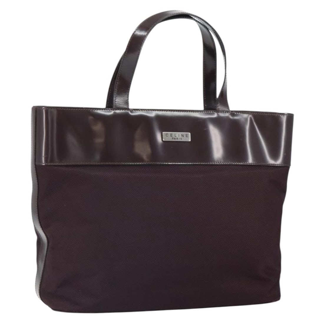 Celine Brown Canvas and Patent Leather Tote Bag Silver Accents: Celine Brown Canvas and Patent Leather Tote Bag Silver Accents This CELINE tote bag features a brown and silver design crafted from canvas with patent leather accents. Made in Italy, it offers a spaci